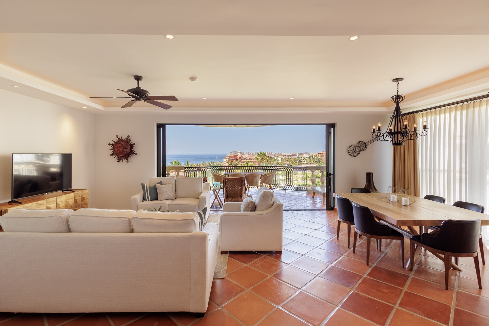 Your bright, open-plan living and dining area flows seamlessly onto a private balcony, where ocean and coastal views create a serene backdrop for relaxing or entertaining.
