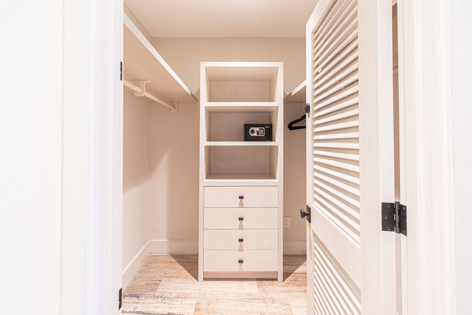 Step into your private walk-in closet with custom built-ins, hanging space, and a personal safe to keep your belongings secure throughout your stay.