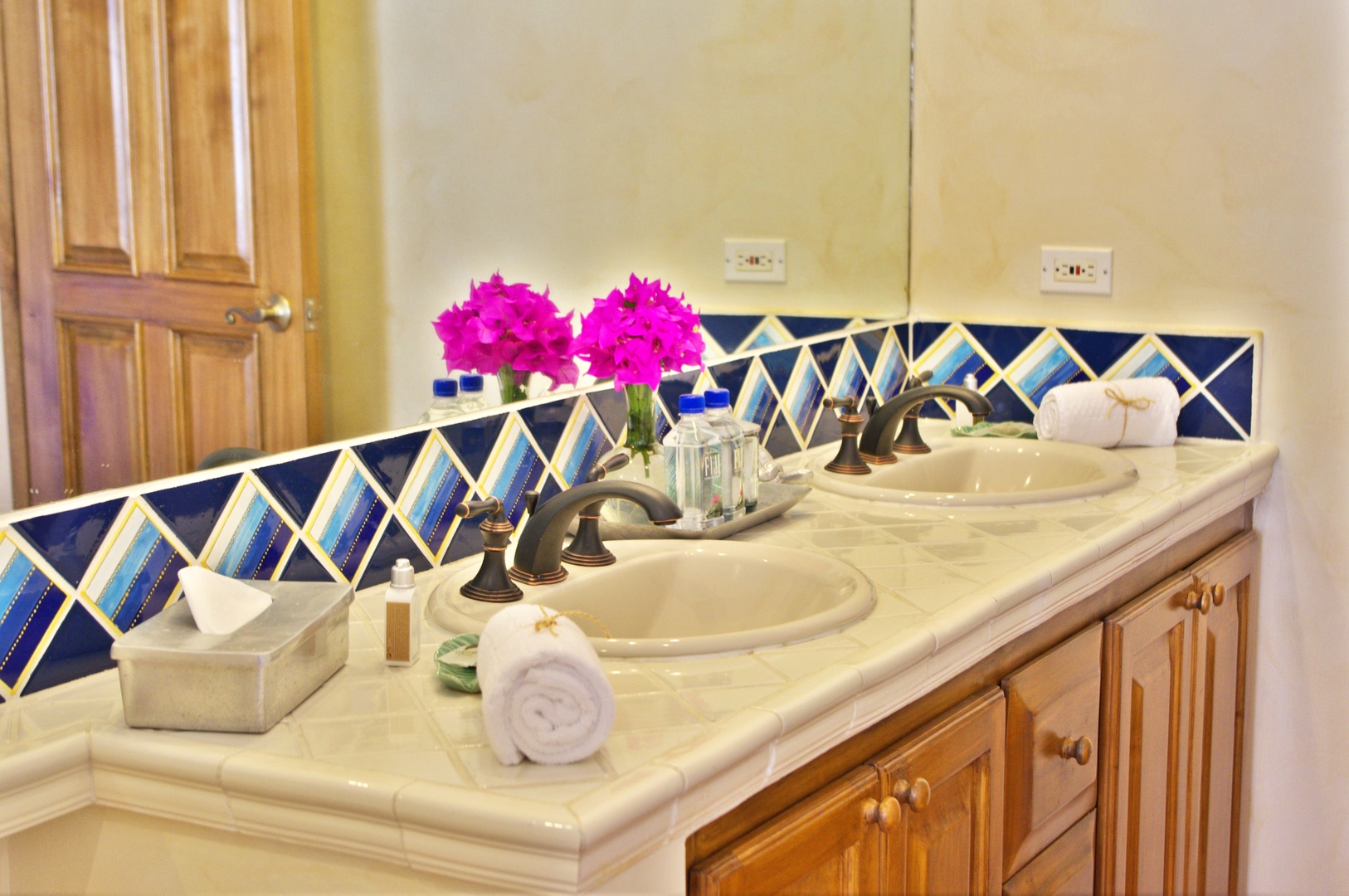 Refresh in your private bathroom featuring dual sinks, vibrant Mexican tilework, and all the comforts you need to feel at home during your getaway.