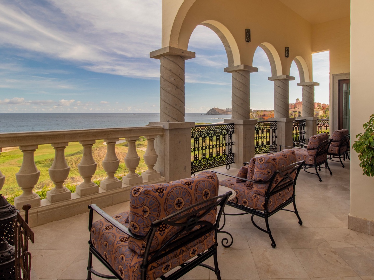 Sweeping sea and coastal views frame your private terrace, where elegant arches and plush seating invite you to unwind in Mediterranean-inspired luxury.