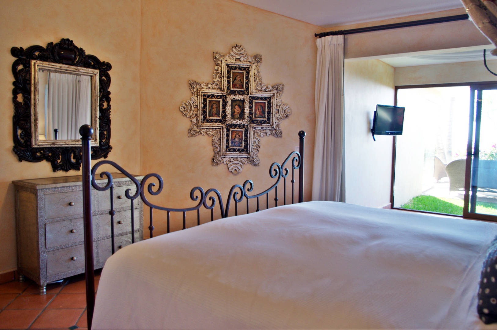 Unwind in your serene retreat featuring elegant furnishings, a plush bed, and charming décor. Step through those doors to your private outdoor space and sunshine.