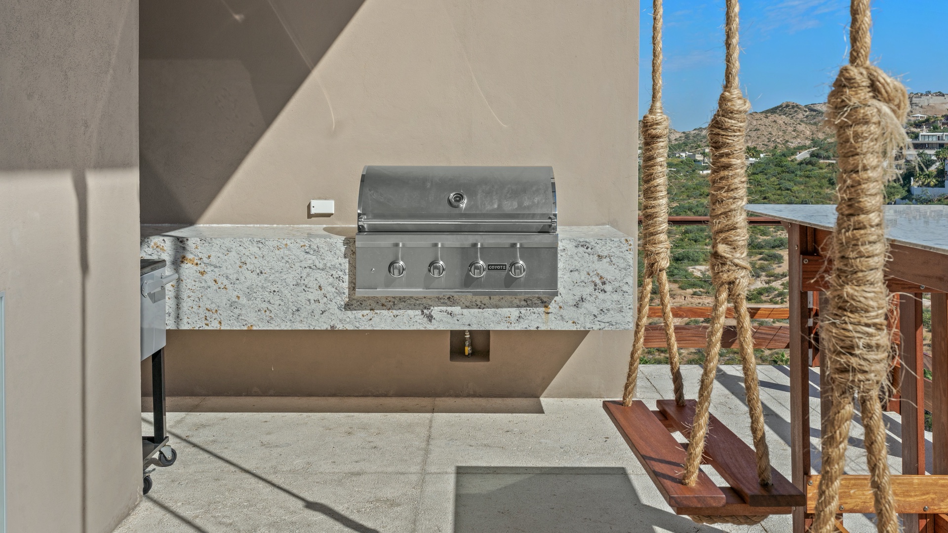Fire up the grill on your private terrace and enjoy mountain vistas while you cook. A swing adds charm to this outdoor escape designed for relaxation and al fresco dining.