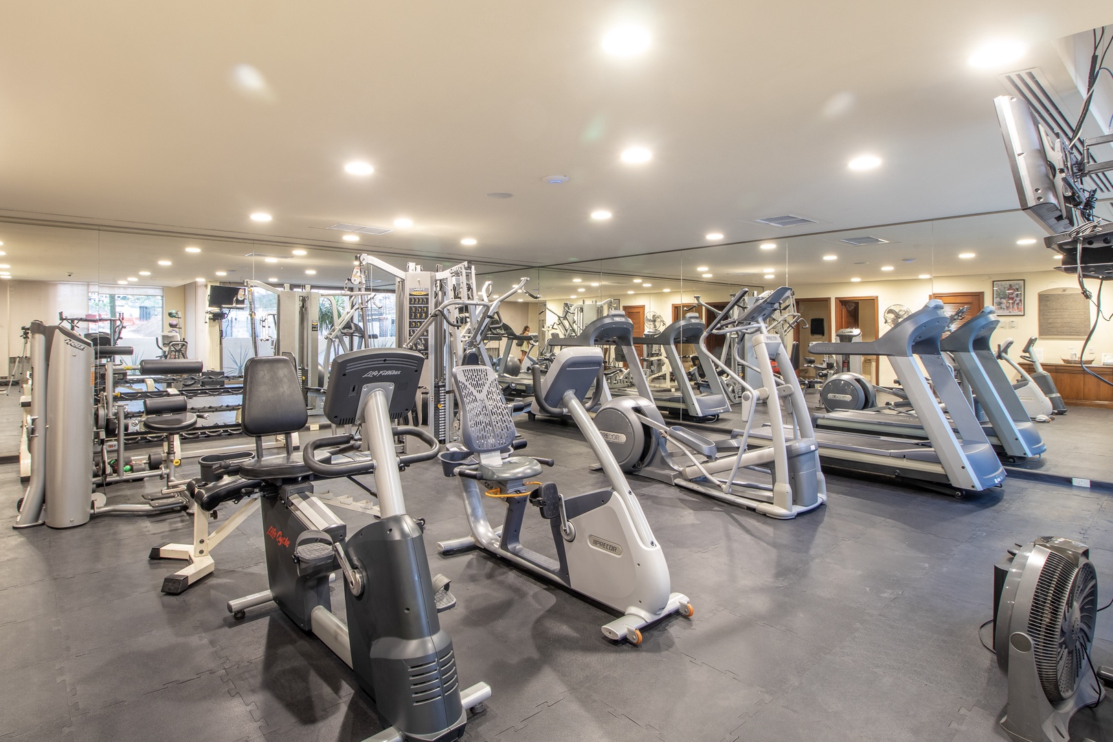 A fully equipped fitness center with cardio machines, weights, and strength training equipment awaits your workout routine whenever you're ready.