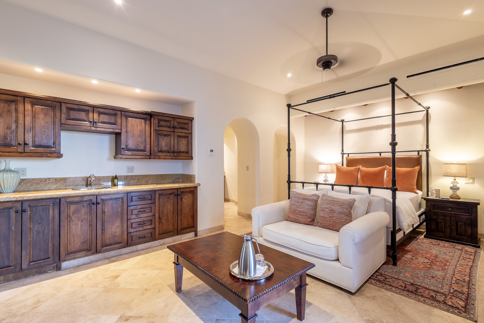 Unwind in your elegant suite featuring a four-poster bed, cozy sitting area, and convenient kitchenette—your personal retreat designed for comfort and relaxation.