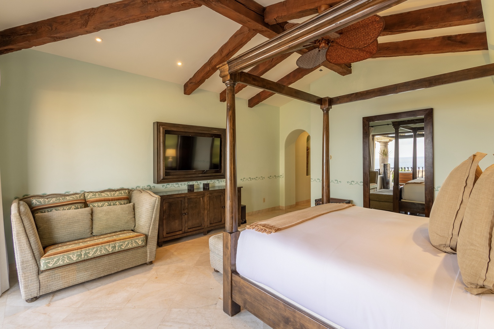 Drift off under dramatic exposed beams in your spacious bedroom. Relax on the plush sofa, enjoy entertainment on the flat-screen, and step out to your private balcony view.