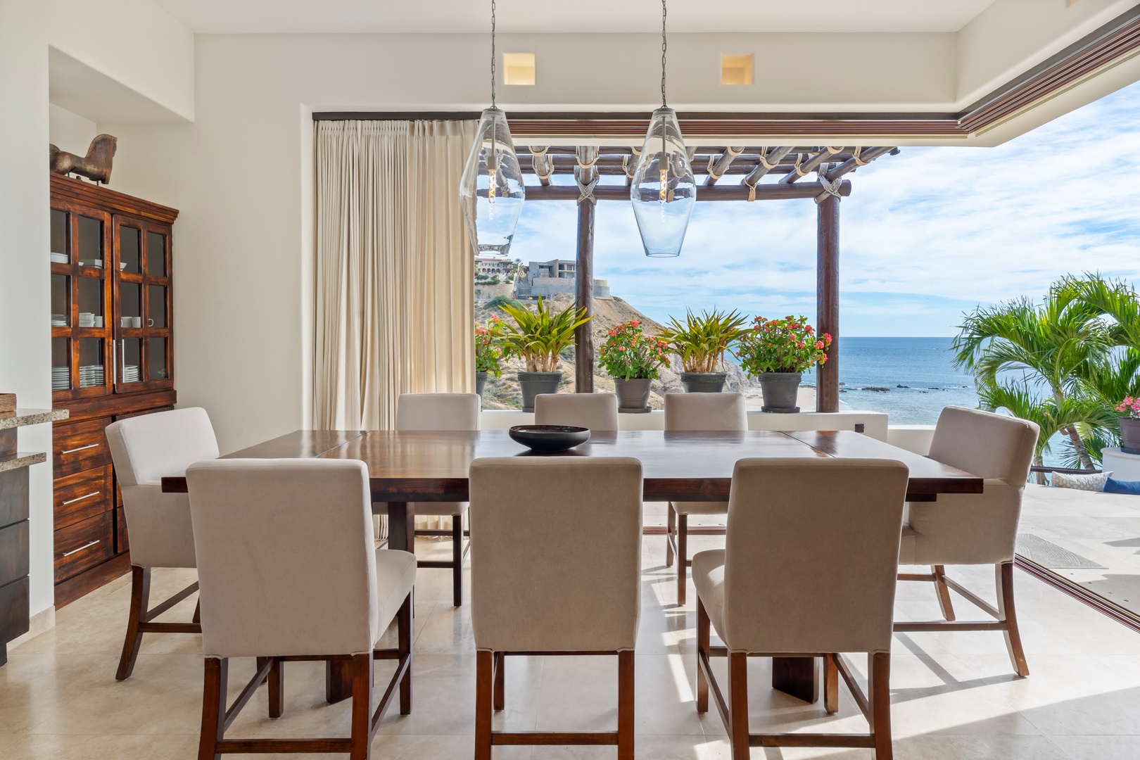Savor meals with breathtaking ocean views from your elegant dining space, where tropical breezes and endless blue horizons create the perfect backdrop.