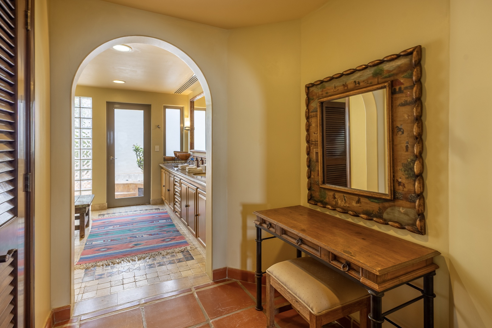 Step through the arched entryway into your warm, welcoming space. Rustic details and thoughtful touches create a comfortable retreat for your stay.