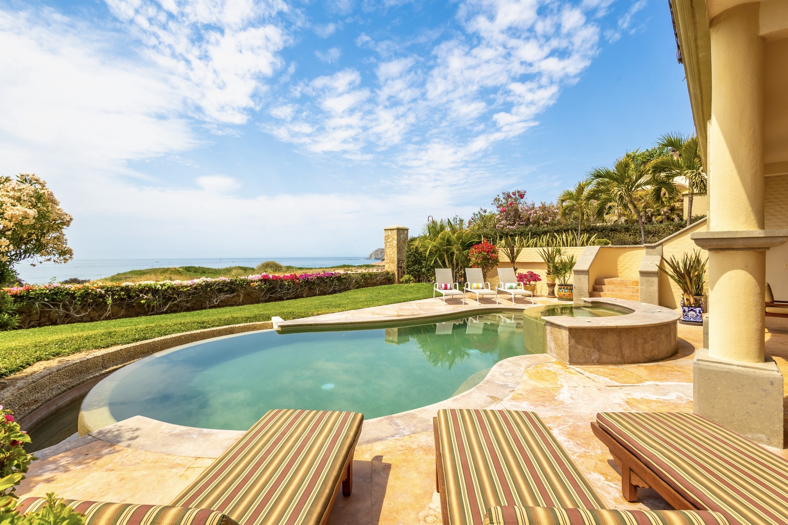 Private pool and hot tub framed by lush gardens and ocean vistas—your personal coastal paradise awaits.