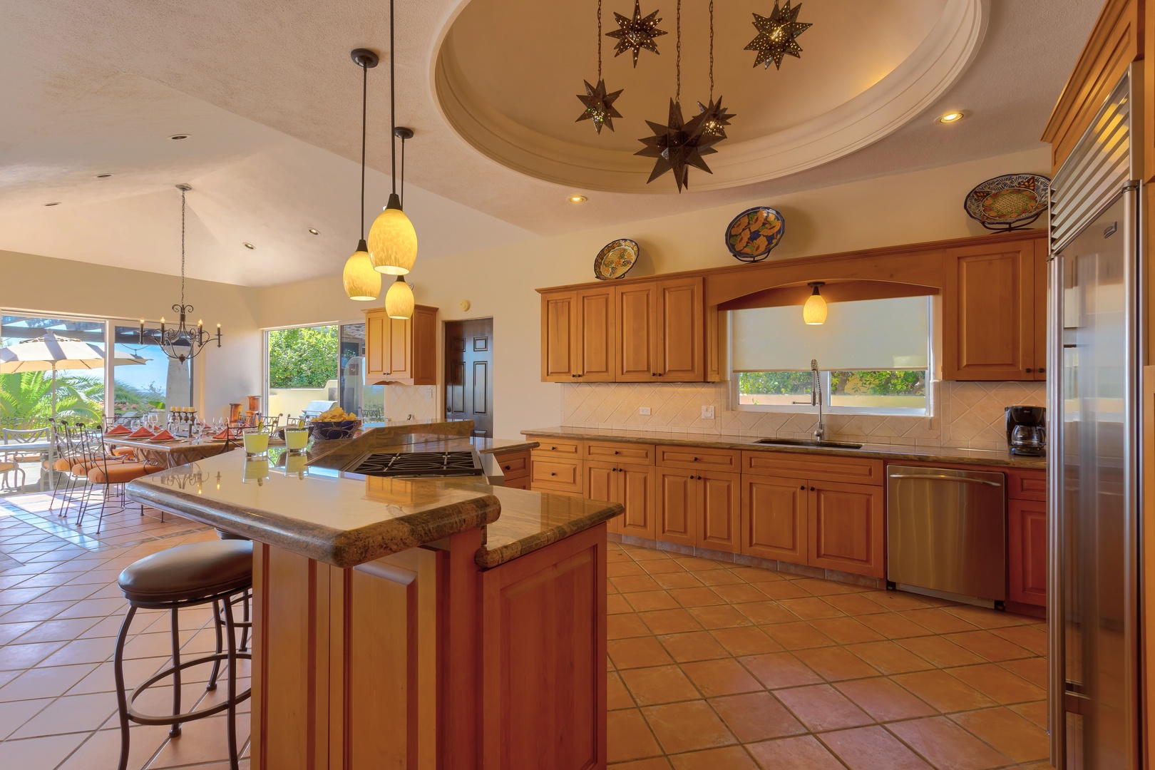 Your spacious gourmet kitchen features warm wood cabinetry, granite counters, and a stunning star-lit dome ceiling—perfect for culinary adventures.