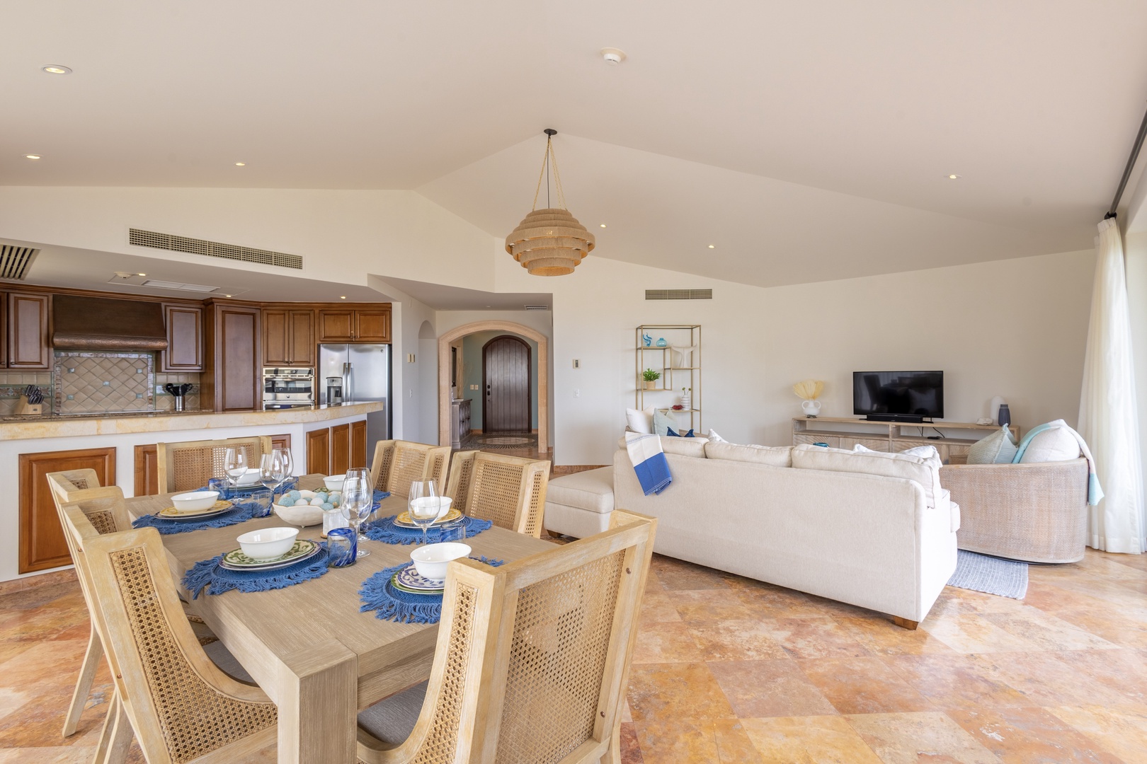 Gather around your spacious dining table while the open kitchen invites culinary adventures and plush seating beckons relaxation.