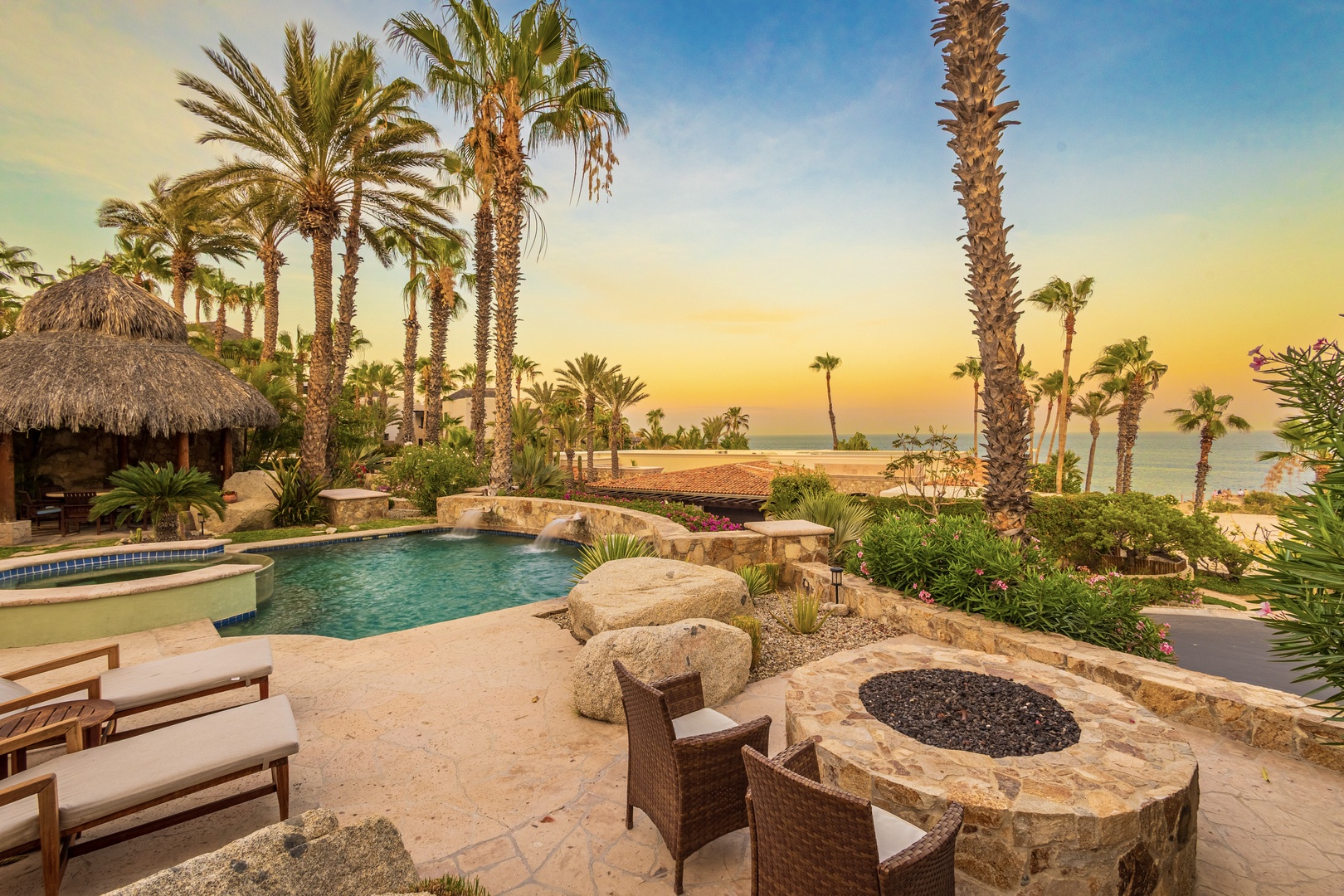 A stunning beachfront retreat where swaying palms frame golden hour views over the sea. Sink into a lounge chair by your private pool, gather around the stone fire pit, and let the warm coastal breeze carry your cares away.
