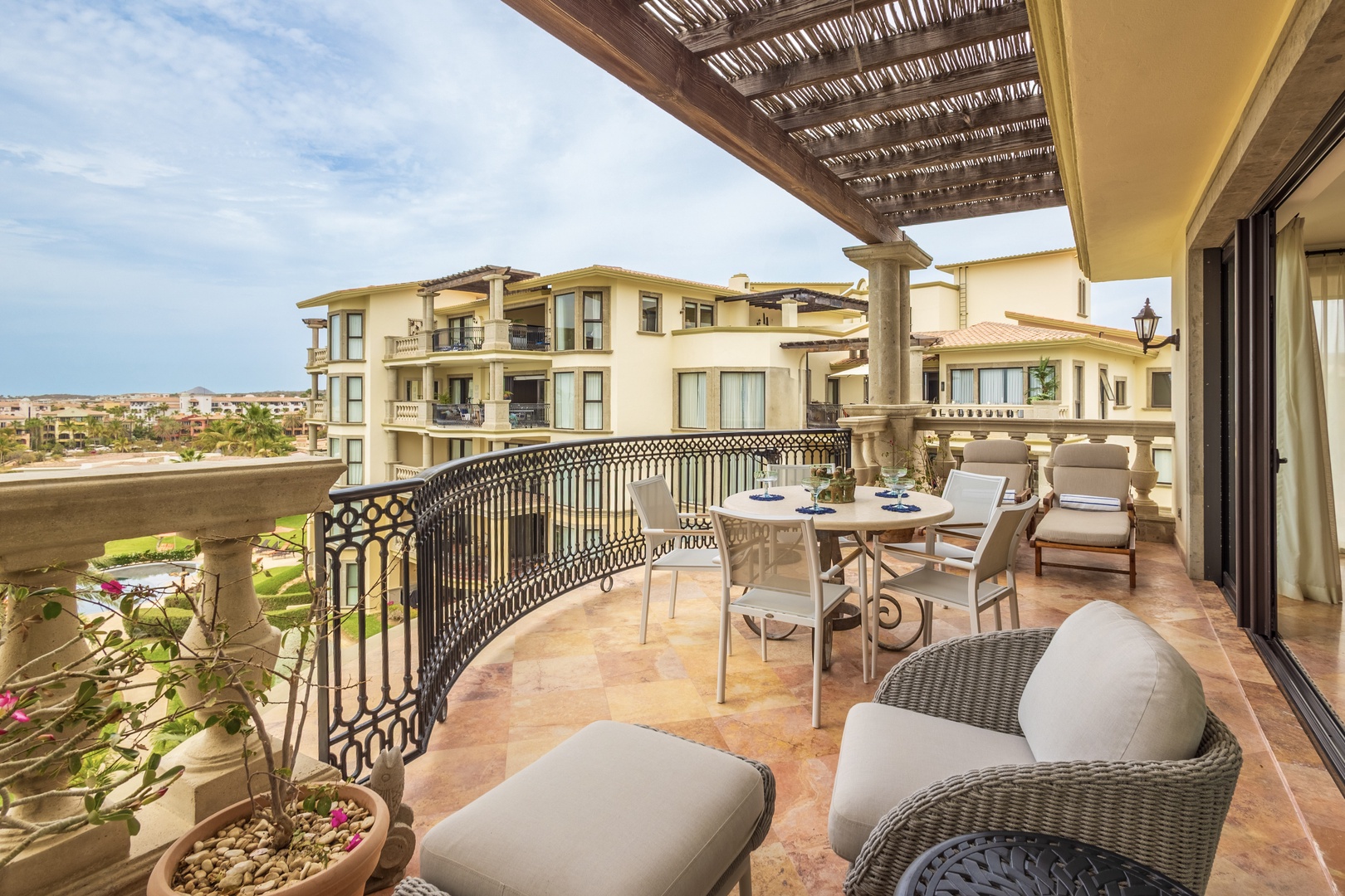 Your spacious terrace invites relaxation with comfortable seating, dining space, and stunning views of the surrounding area.