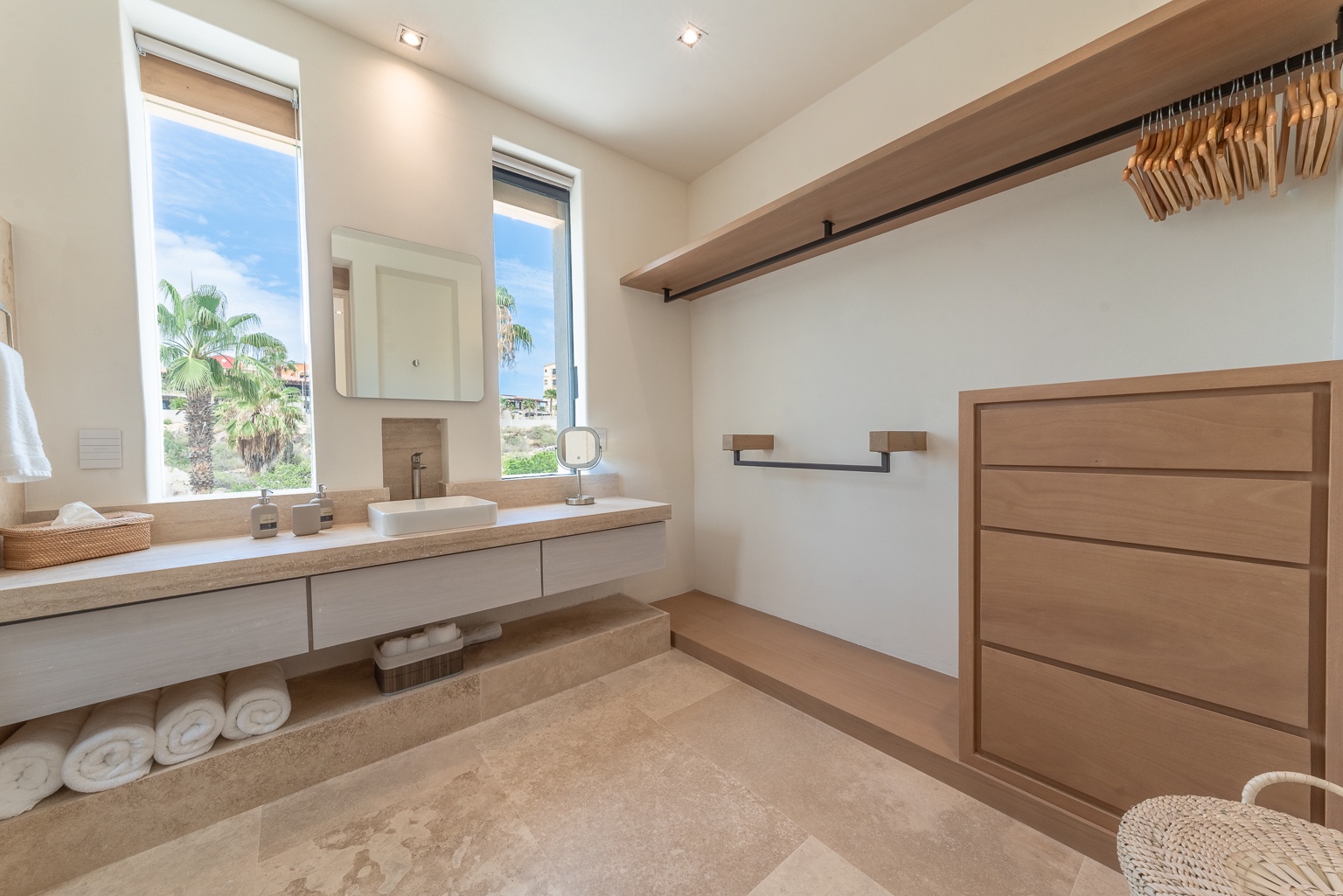 Step into your serene retreat—warm woods, natural light, and palm views create a spa-like escape where you'll start every day refreshed and inspired.