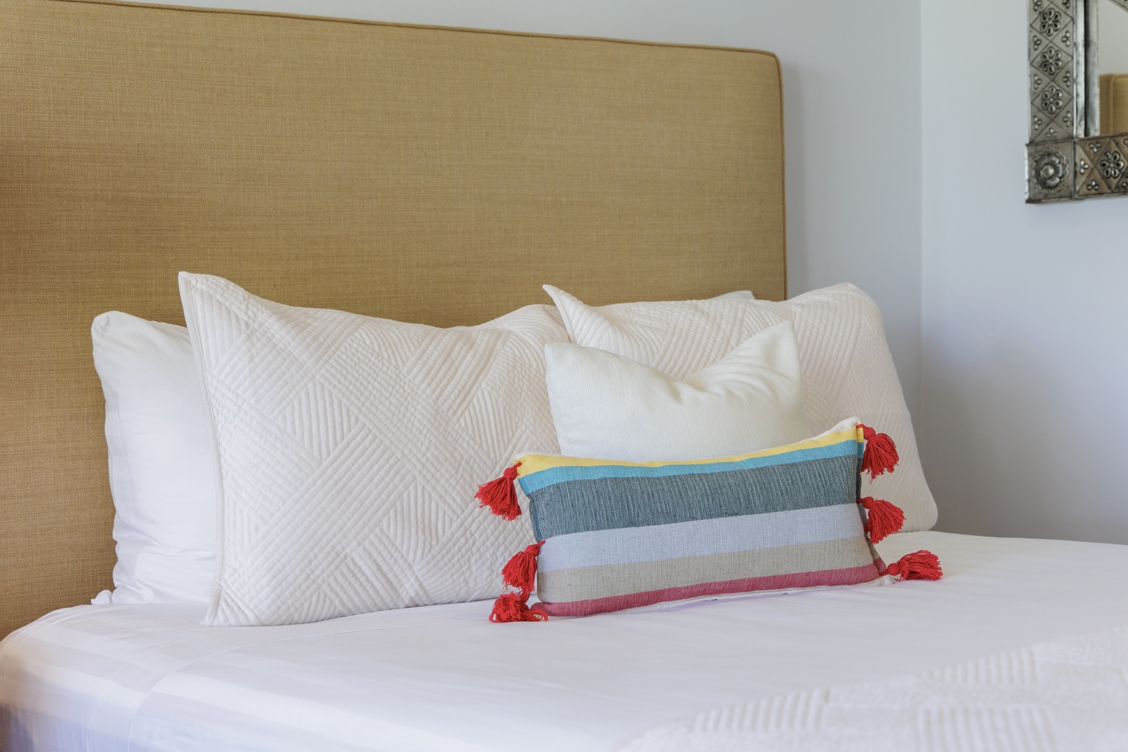 Sink into plush white linens and crisp pillows after a day of adventure. Your cozy retreat awaits with thoughtful touches and a calming neutral palette.