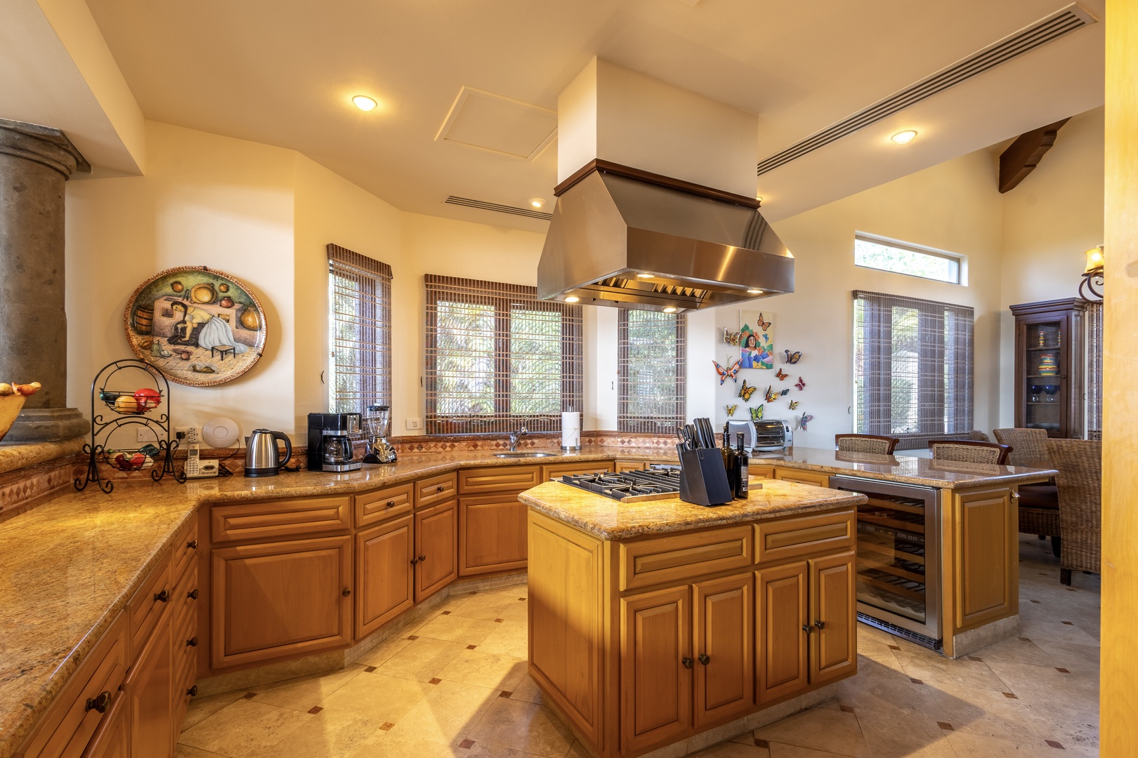 Picture yourself preparing meals in this spacious, light-filled kitchen with beautiful granite counters, a chef-worthy island stove, and plenty of room to gather. The warm cabinetry and charming decor create a welcoming atmosphere where you can cook, conn