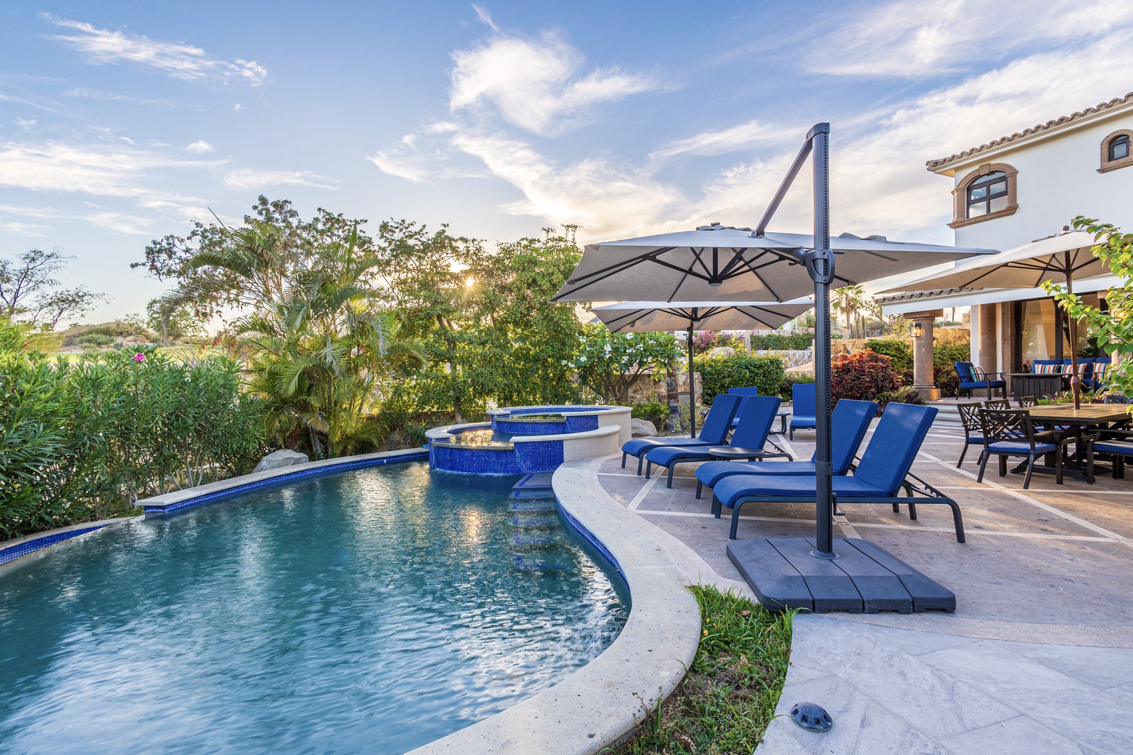 Lounge poolside under the shade, surrounded by lush tropical gardens and stunning sunset views. Your private oasis awaits for refreshing dips and unforgettable outdoor relaxation.