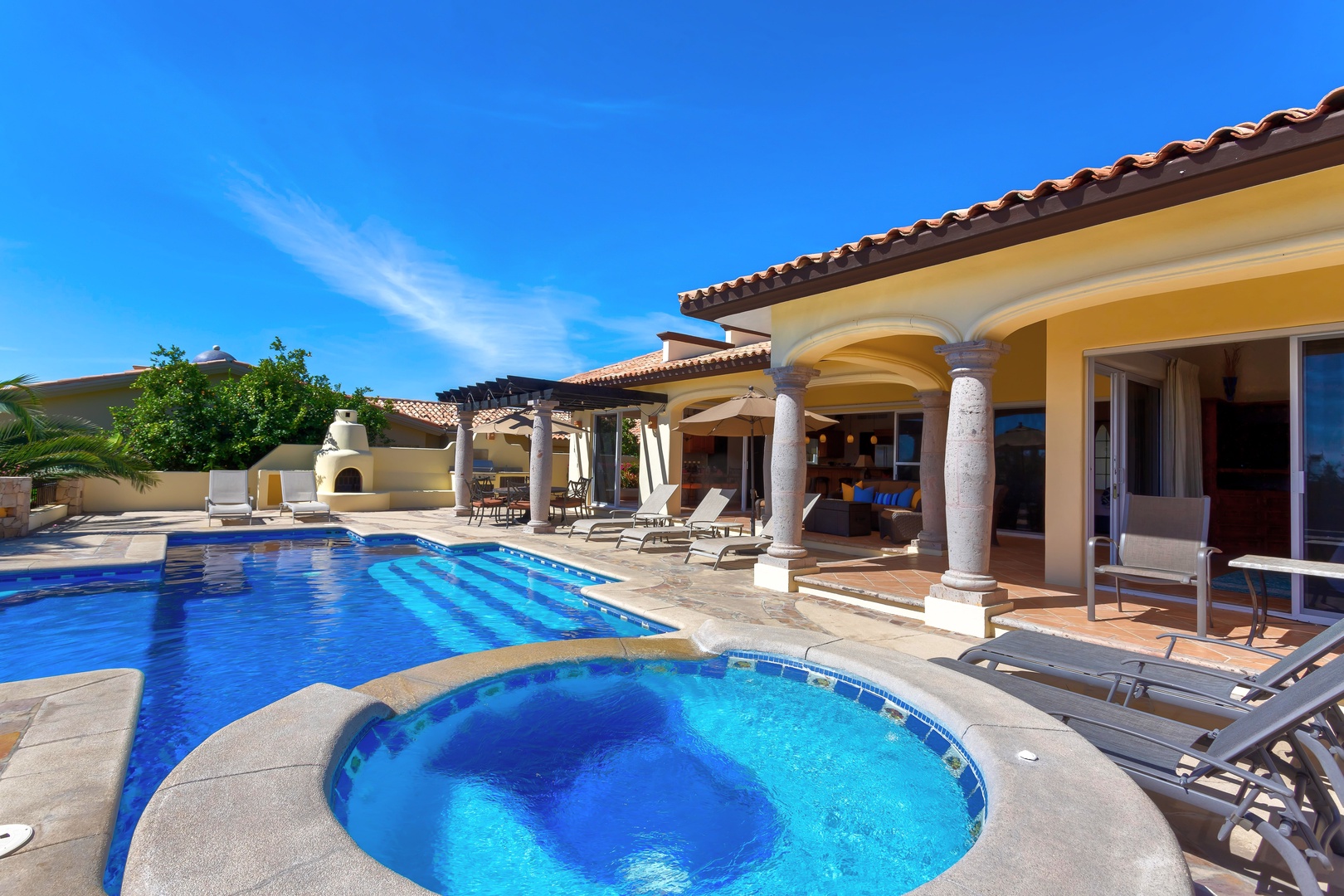 Dive into your private oasis with this stunning pool and spa, perfect for morning swims and sunset soaks under endless blue skies.