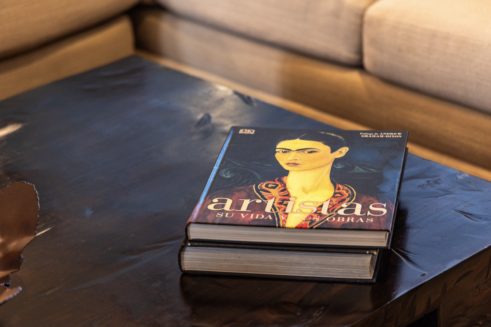 Browse through the coffee table books and settle into the plush sofa—your perfect spot to relax and unwind.