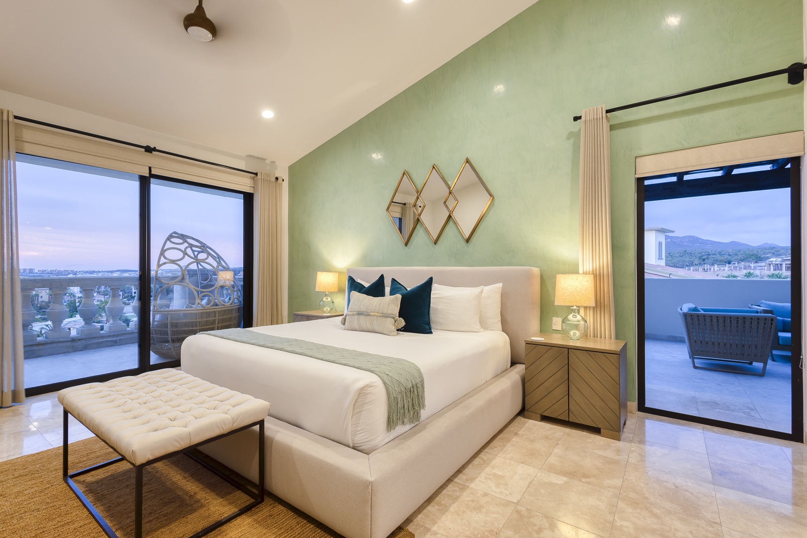 Picture yourself unwinding in this serene retreat, where plush linens meet calming green tones. Step onto your private terrace and breathe in mountain views that frame your escape.