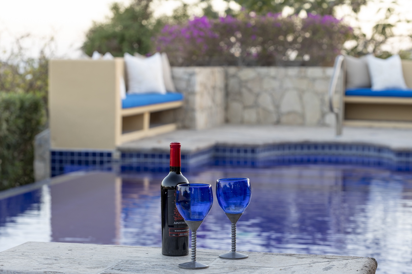 Sip wine poolside while soaking in the serene blue waters and comfortable lounge seating.