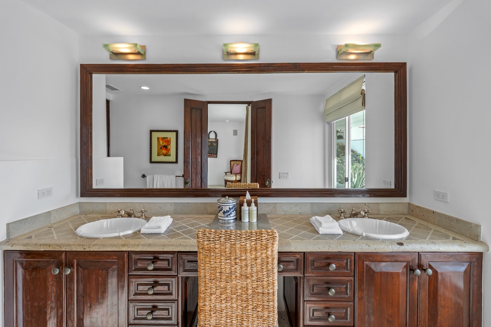 Your spacious double vanity bathroom features elegant marble countertops, rich wood cabinetry, and premium lighting for your morning routines.