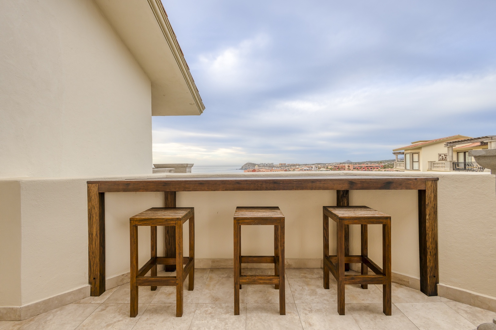Settle into your private balcony perch, where coastal panoramas unfold before you—perfect for morning coffee or sunset cocktails as the ocean breeze drifts in.