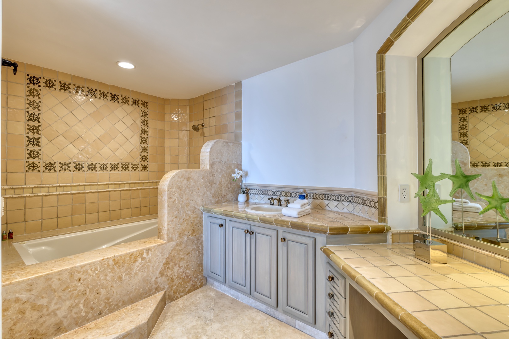 Unwind in your spacious bathroom featuring a deep soaking tub, elegant tilework, and dual vanities—perfect for refreshing after a day of adventure.