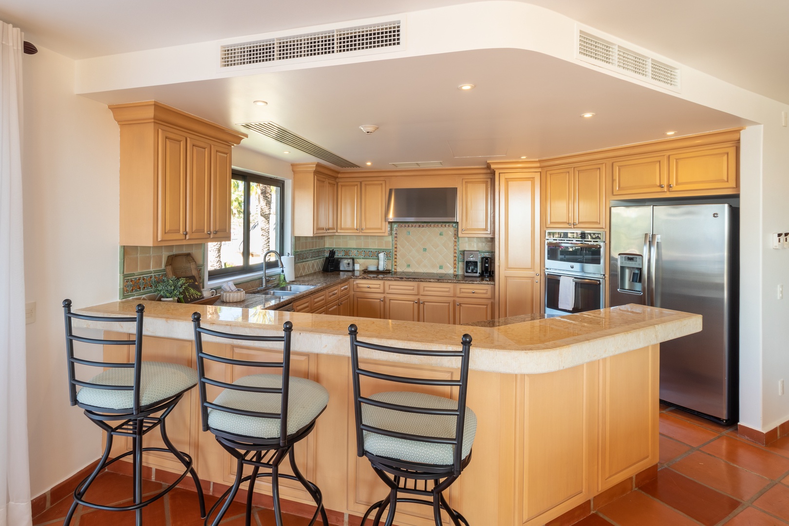 Your gourmet kitchen features a spacious island with bar seating, perfect for gathering with family and friends while preparing delicious meals in this fully-equipped space.