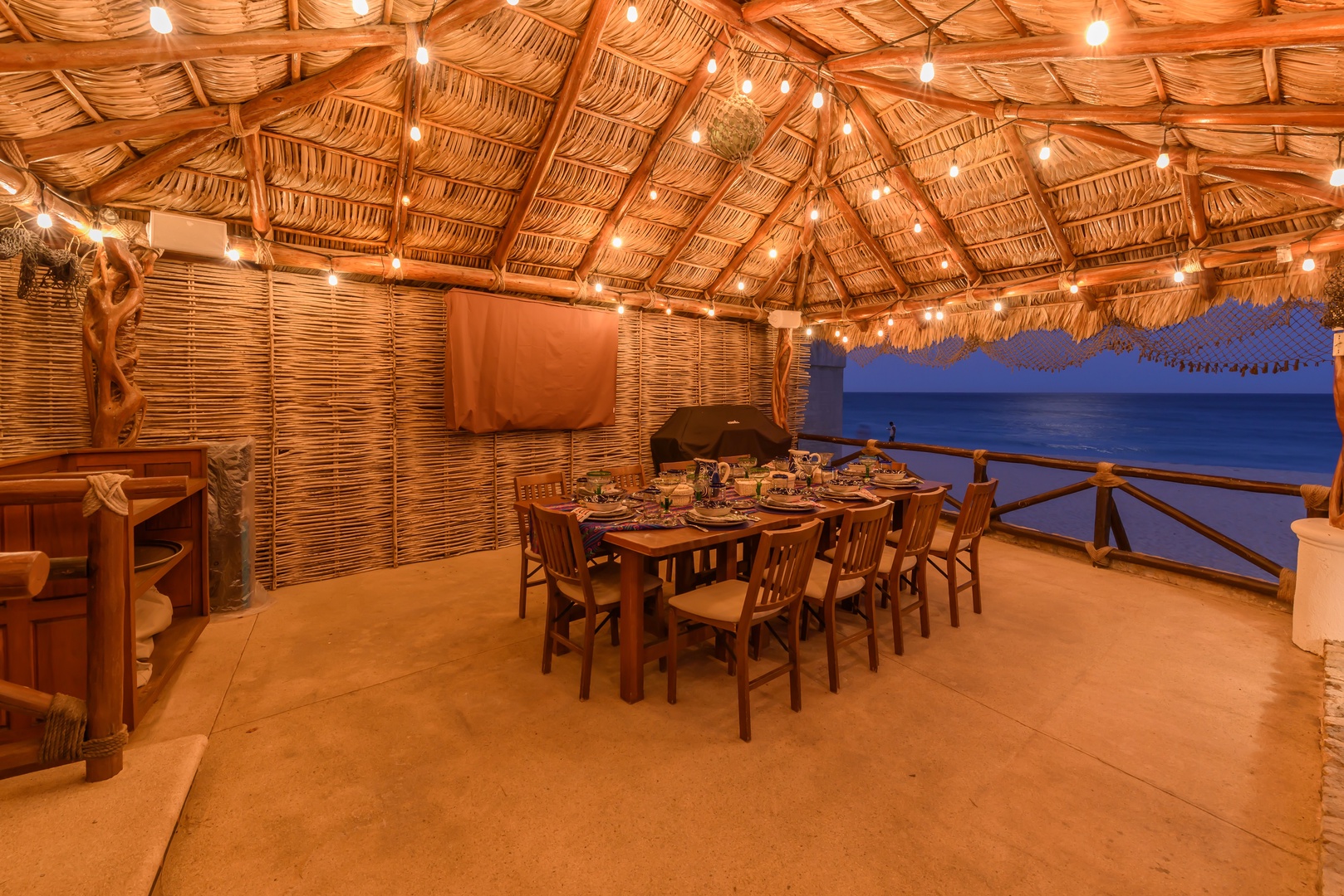 Gather under twinkling lights at your private palapa dining space, where ocean views and tropical charm create unforgettable evenings by the sea.