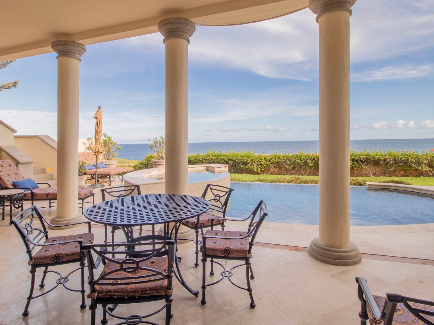Dine under elegant columns while gazing at the endless blue ocean stretching to the horizon. Your own private infinity pool awaits just steps away, perfectly framed by manicured gardens.