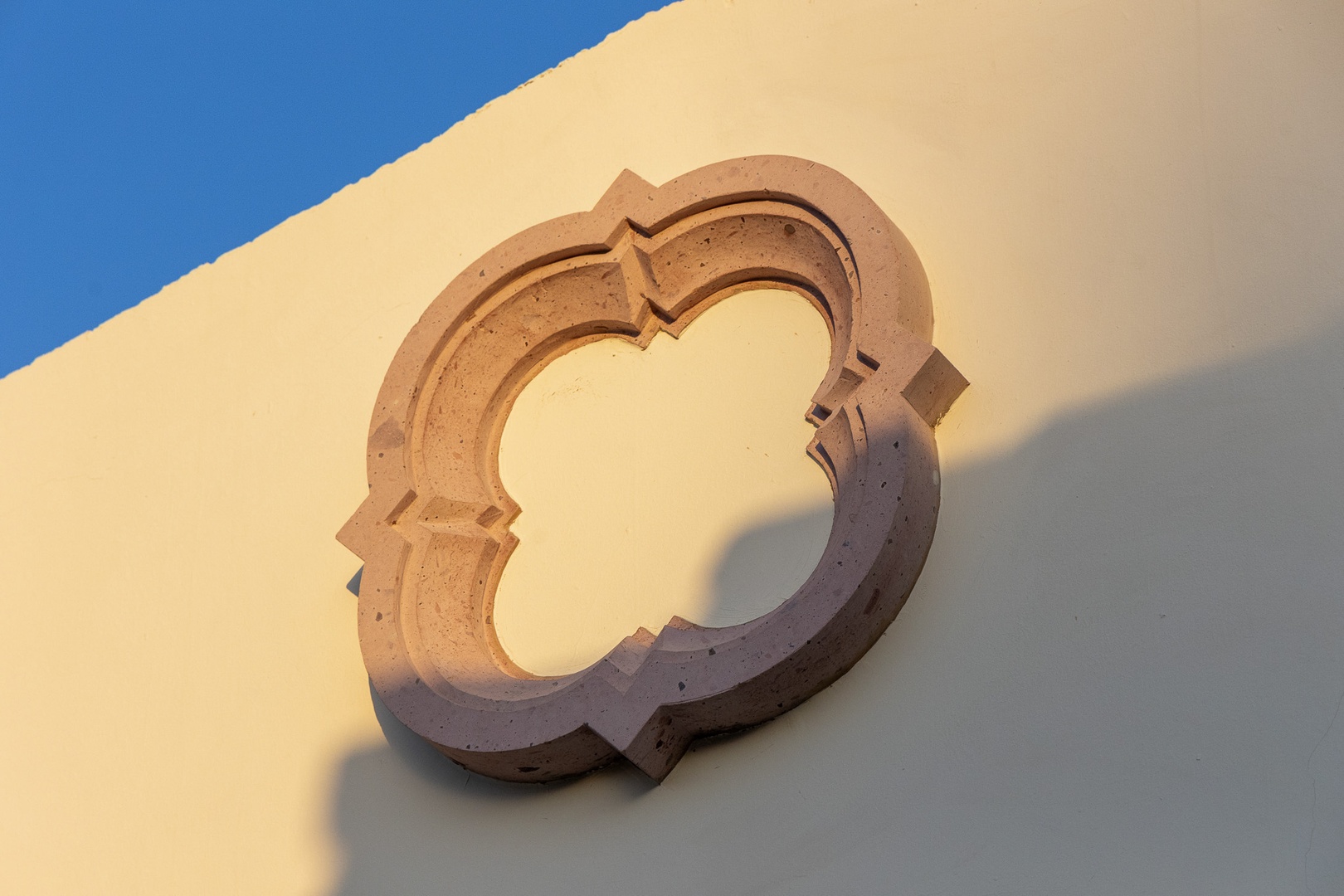 A decorative architectural detail with elegant curves and soft shadows creates visual interest on the property's exterior façade, showcasing the building's distinctive design elements.