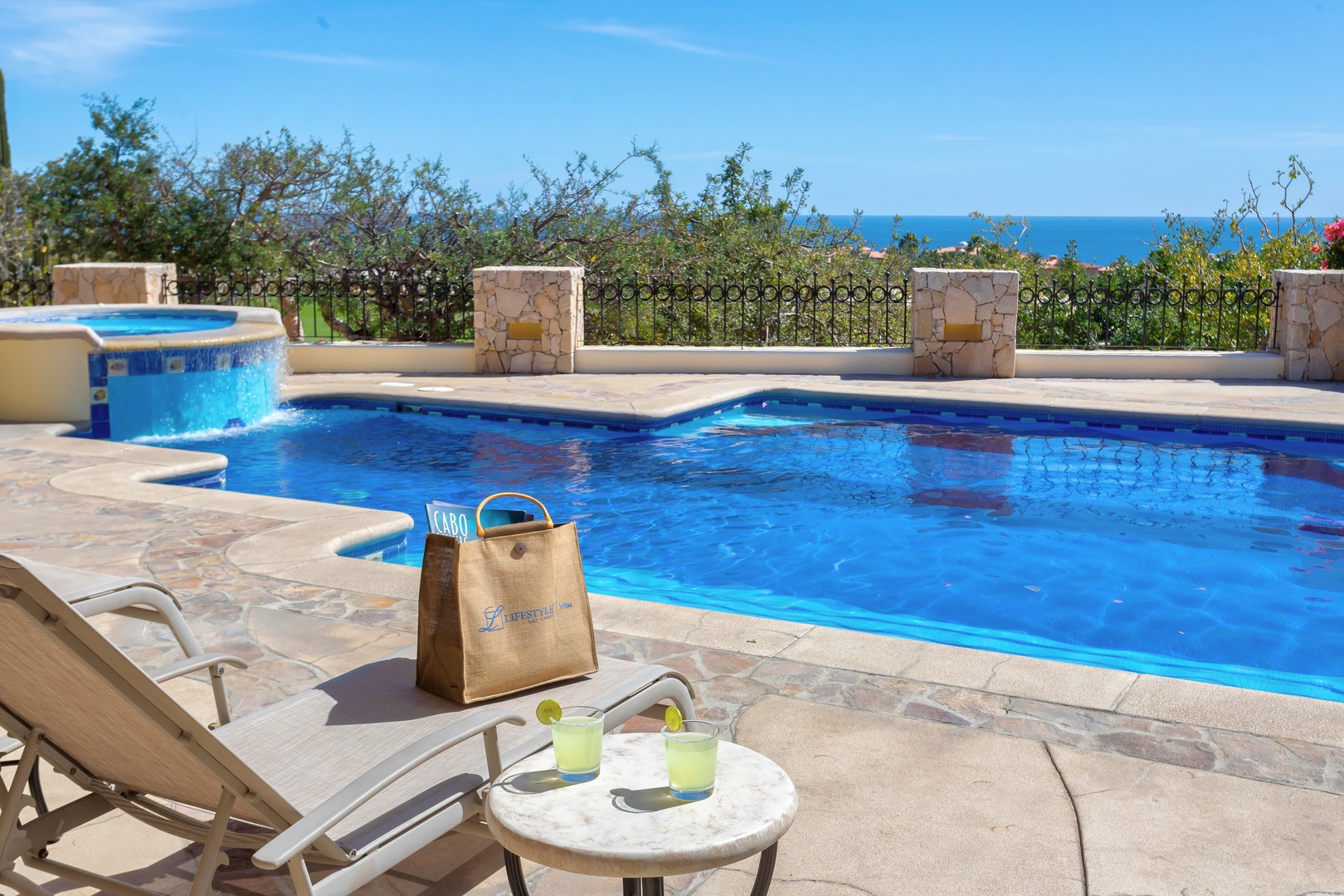 Sip your morning drink by the crystal-clear pool while gazing at endless ocean views beyond the lush garden.