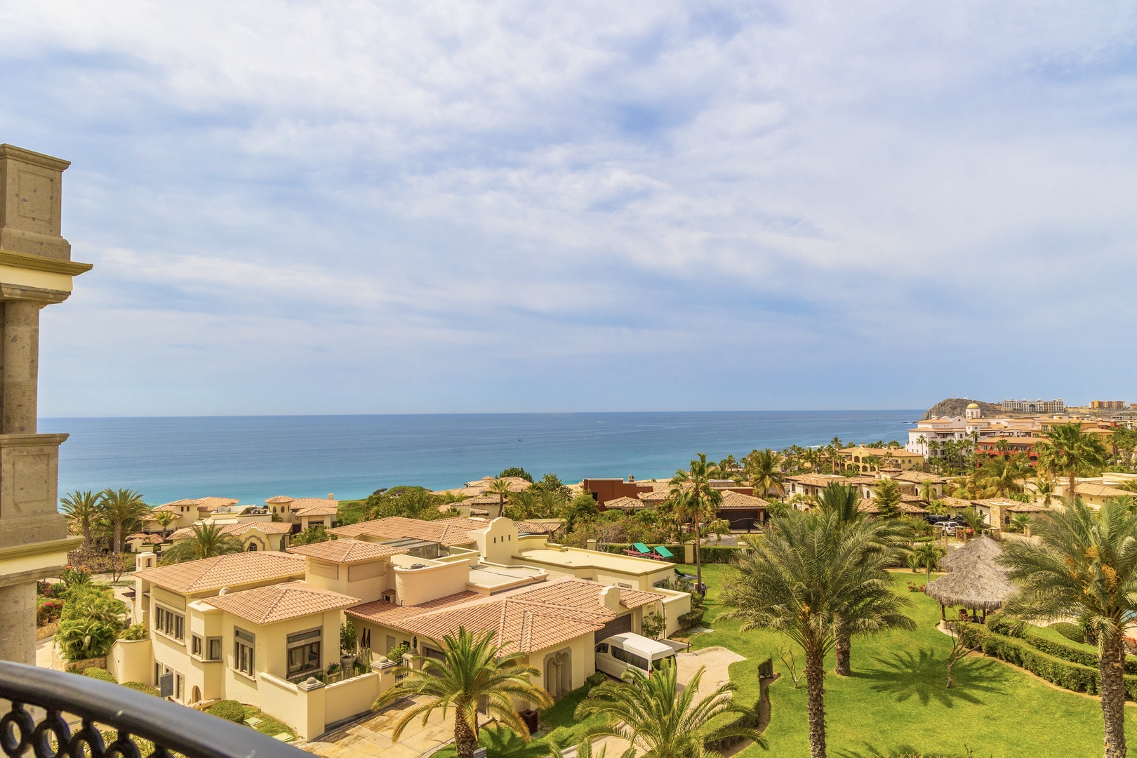 Stunning ocean views stretch to the horizon from this elevated coastal community, showcasing Mediterranean architecture and pristine blue waters.
