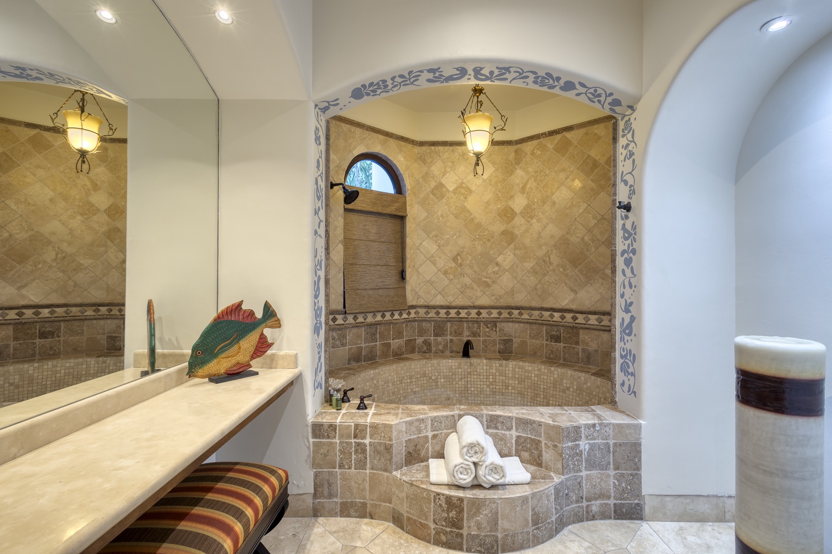 Unwind in your luxurious stone-tiled soaking tub, surrounded by elegant archways and warm lantern lighting that creates a spa-like sanctuary.