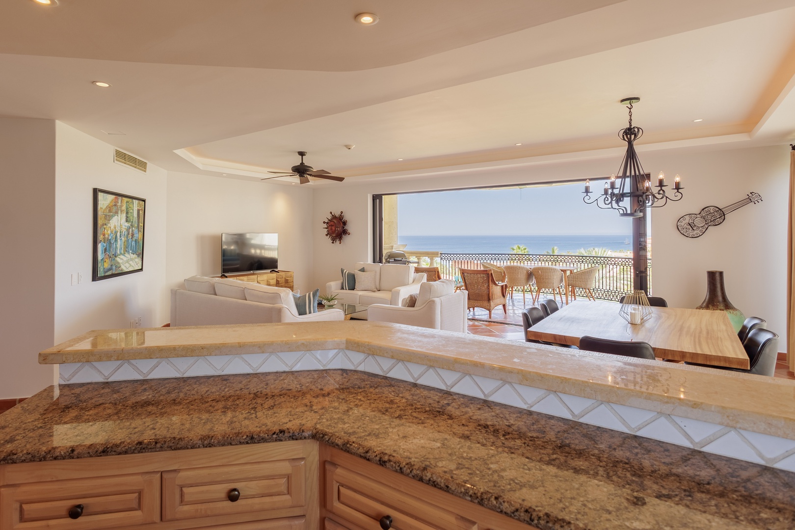 Open, airy living flows seamlessly to your private balcony, framing sparkling sea views. Gather around the kitchen island, relax in comfort, and soak in coastal breezes.