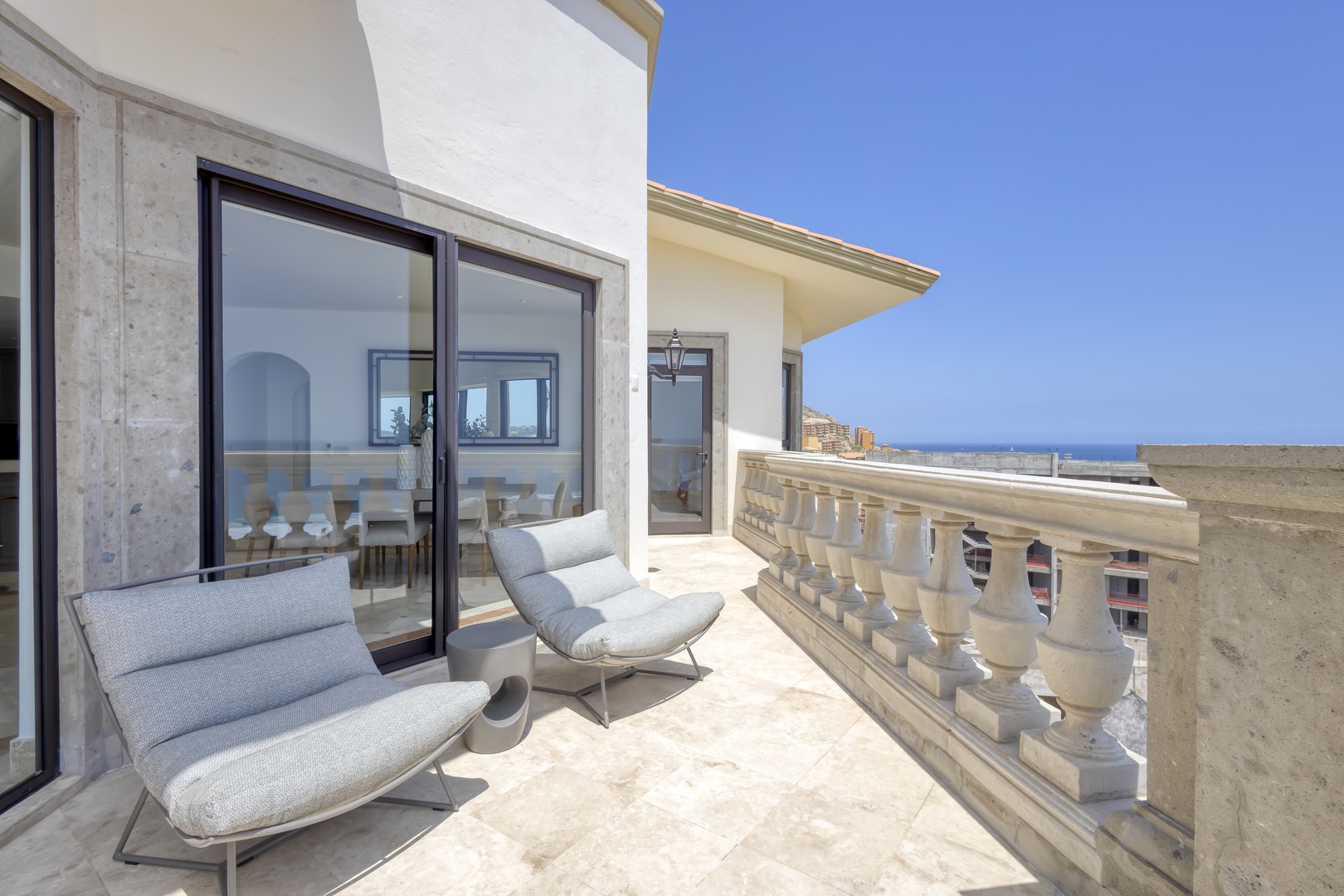 Step onto your private balcony and unwind on modern lounge chairs while soaking in stunning sea views. This open-air retreat is perfect for morning coffee or evening relaxation.