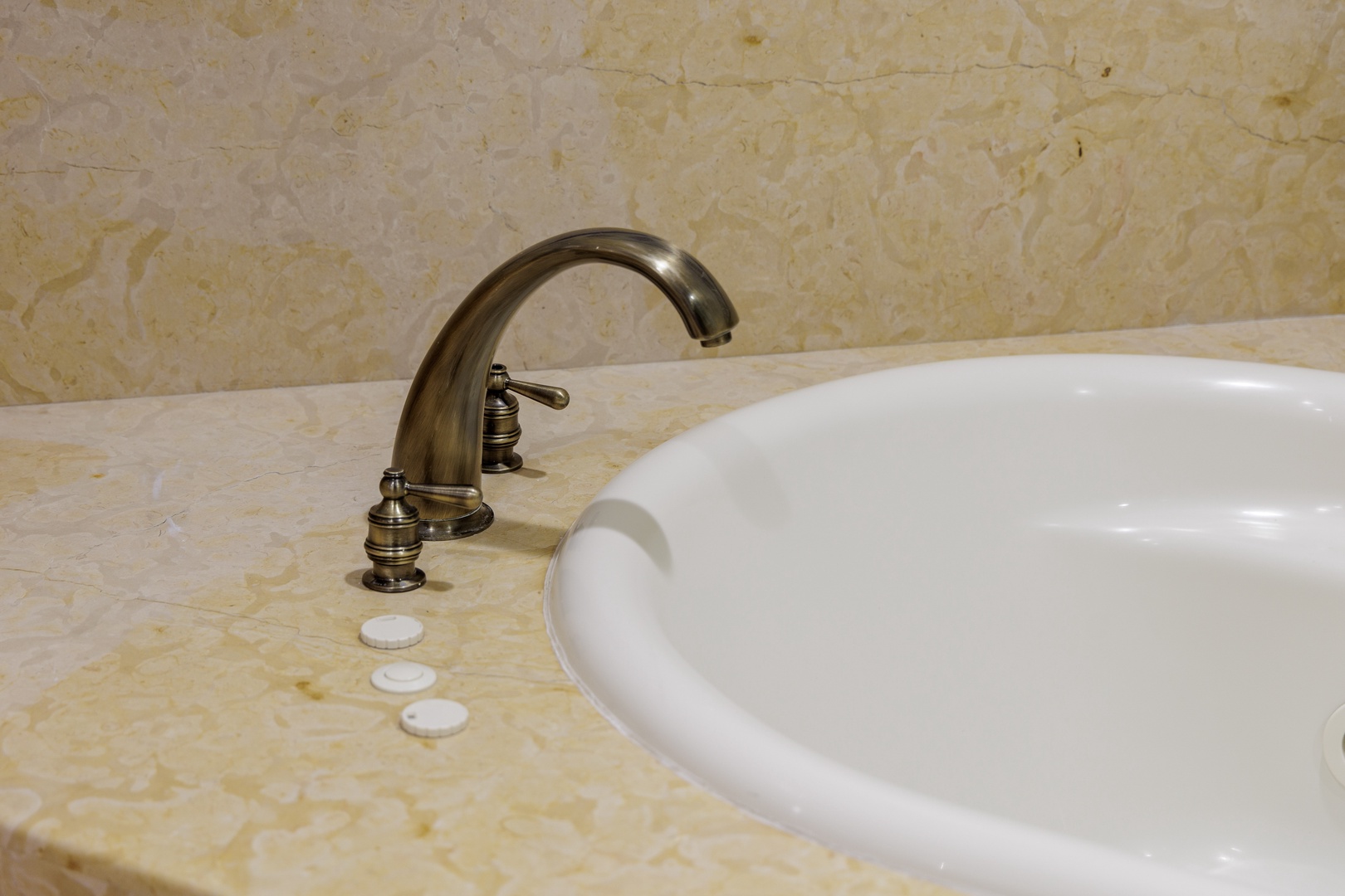 Slip into your own private soaking tub, featuring elegant marble surroundings and antique-brass fixtures that add a touch of vintage charm to your relaxation time.