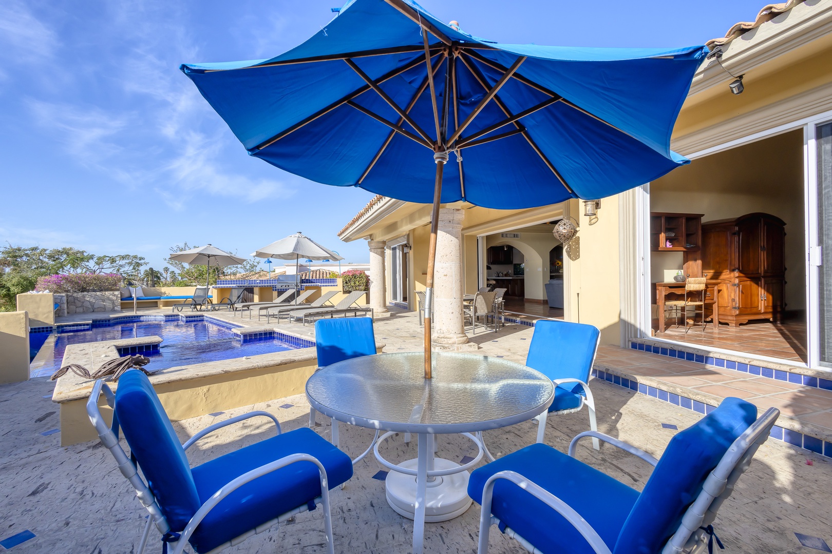 Relax poolside under your private blue umbrella, enjoying breathtaking villa views and crystal-clear waters.
