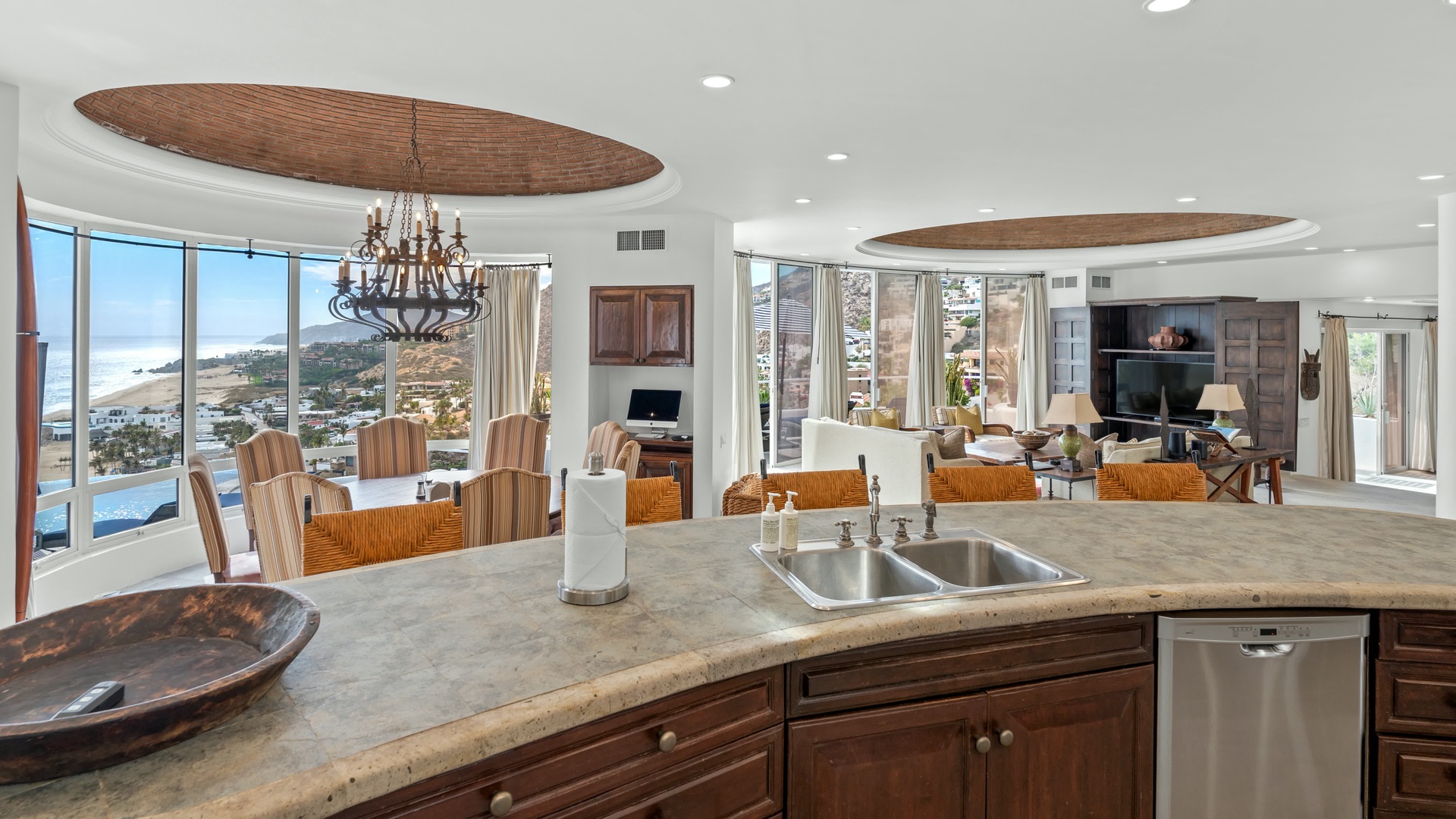 Cook with stunning coastal views stretching across your kitchen windows, where granite counters and modern appliances meet breathtaking panoramas.