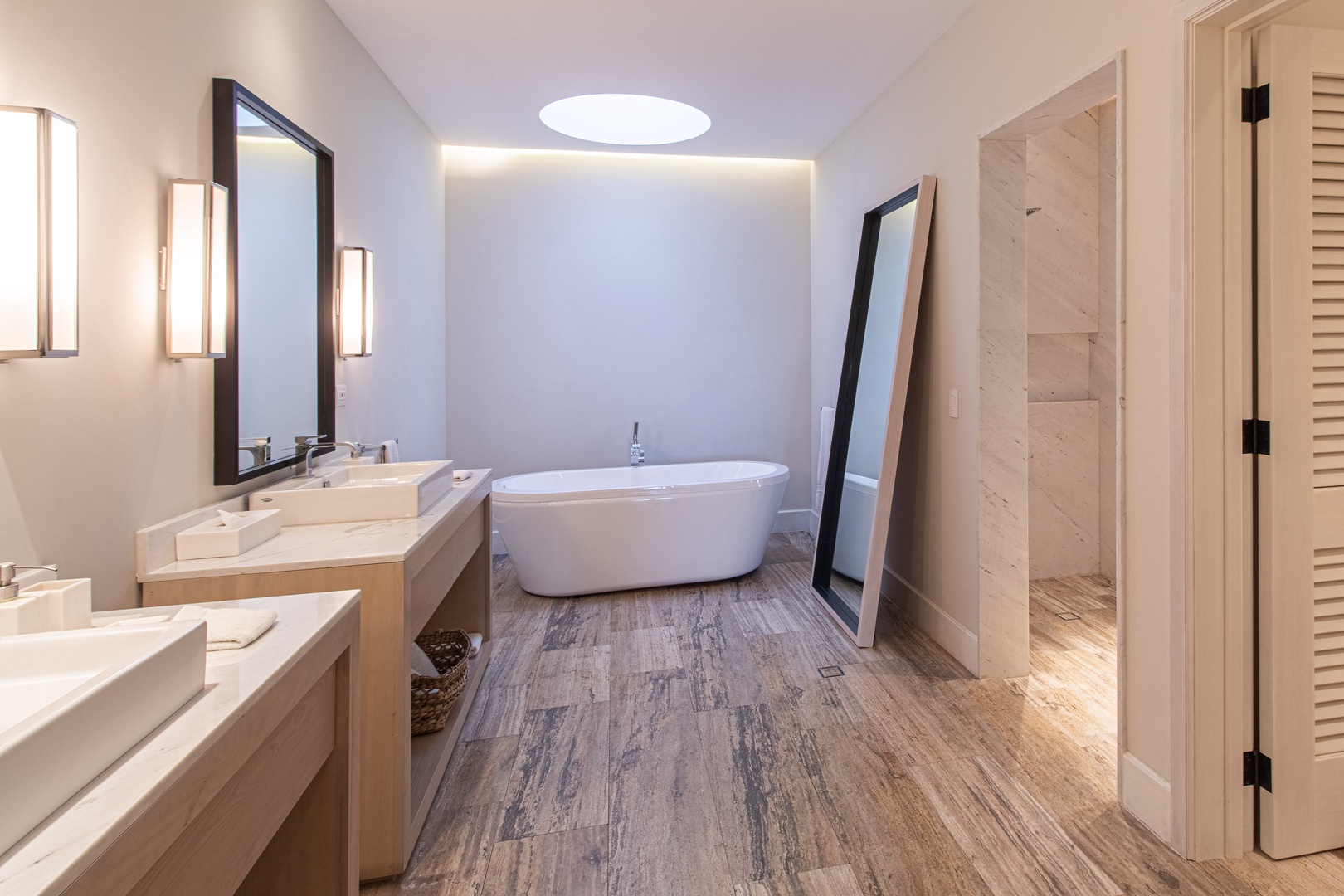 Unwind in your spa-inspired ensuite, where a soaking tub awaits beneath soft ambient lighting and dual vanities offer modern comfort in a serene, elegant sanctuary.