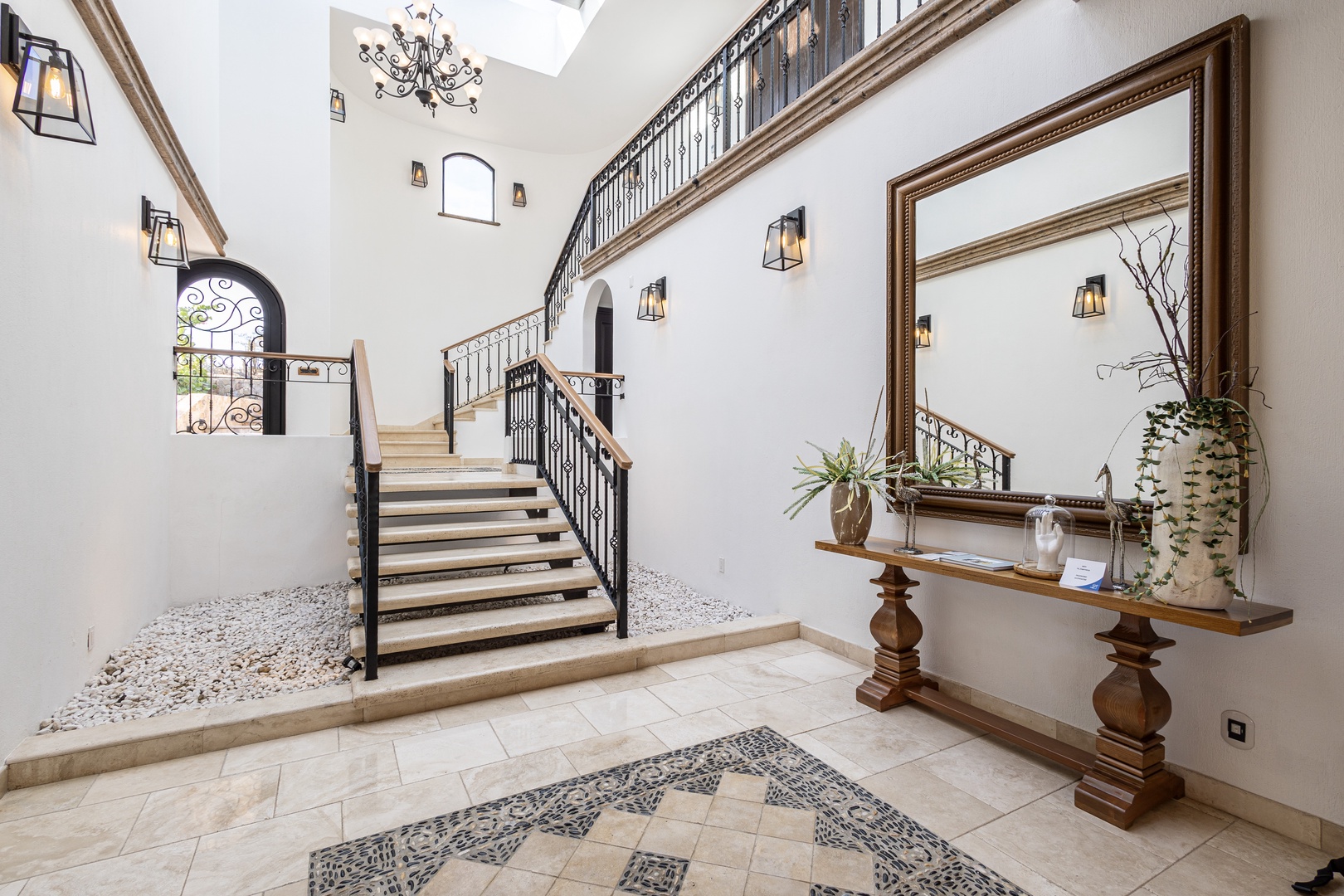 Enter a grand foyer where natural light pours through soaring ceilings, and elegant wrought-iron staircases beckon you upward. Your home away from home begins here.