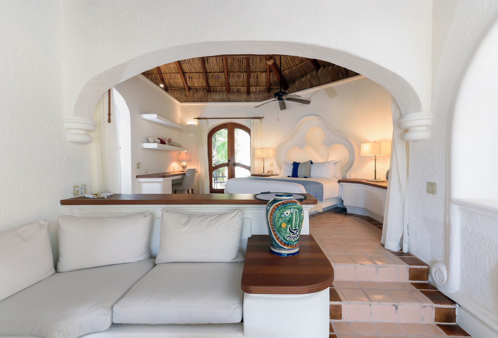 Your private oasis awaits with a flowing open layout that blends a sunlit living space, cozy bedroom nook, and charming thatched palapa ceiling for a truly authentic retreat.