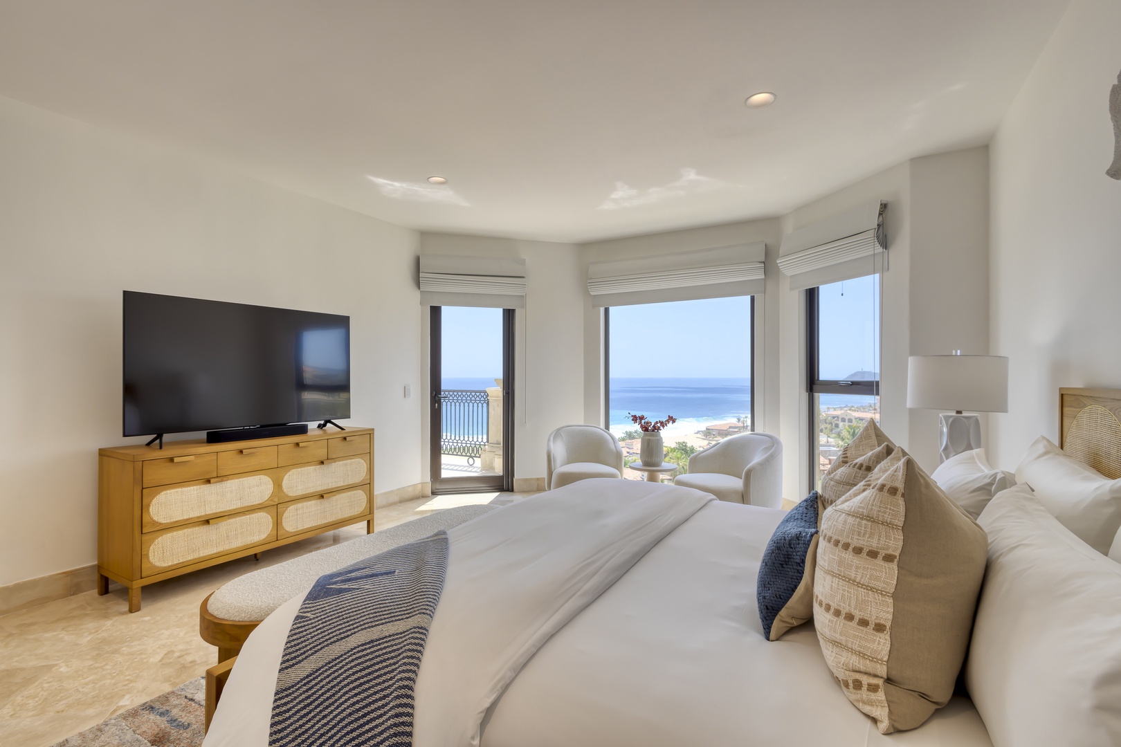 Wake up to breathtaking ocean views from your comfortable bed, with sliding doors opening to a private balcony. The serene coastal tones and natural textures create a peaceful retreat where you can unwind in style.