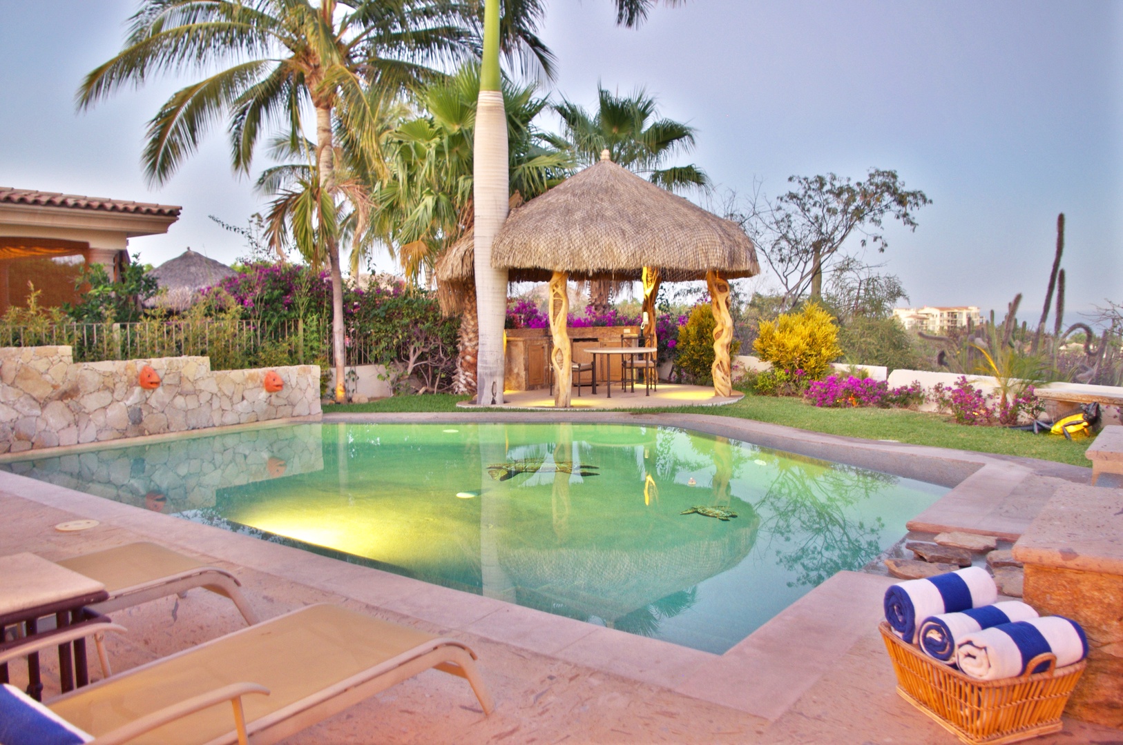 Your private pool awaits, framed by swaying palms and vibrant gardens. Lounge poolside, gather under the palapa, or simply soak in the serene atmosphere.