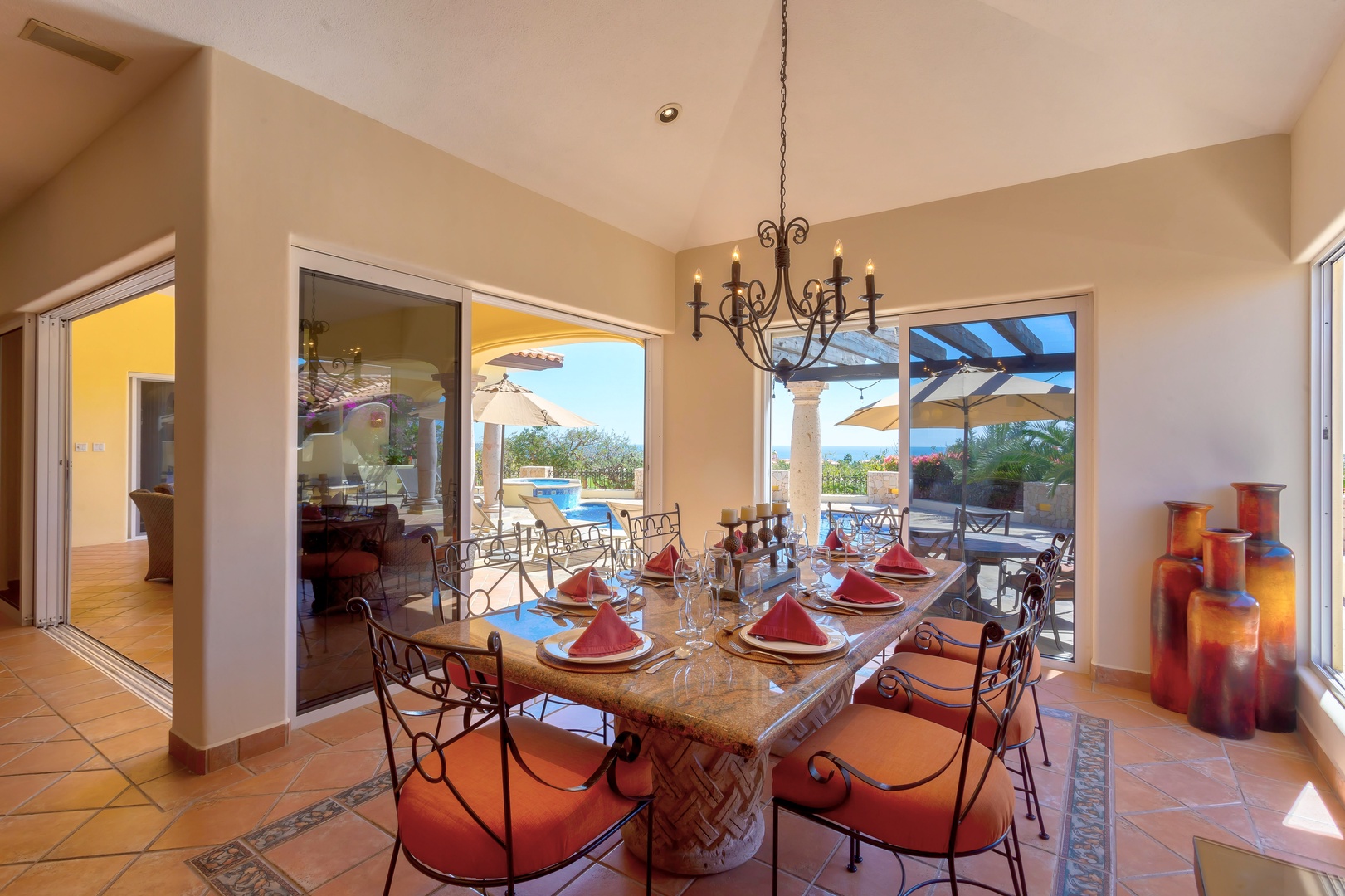 Savor memorable meals in your elegant dining space, where warm light filters through expansive windows revealing stunning outdoor views.