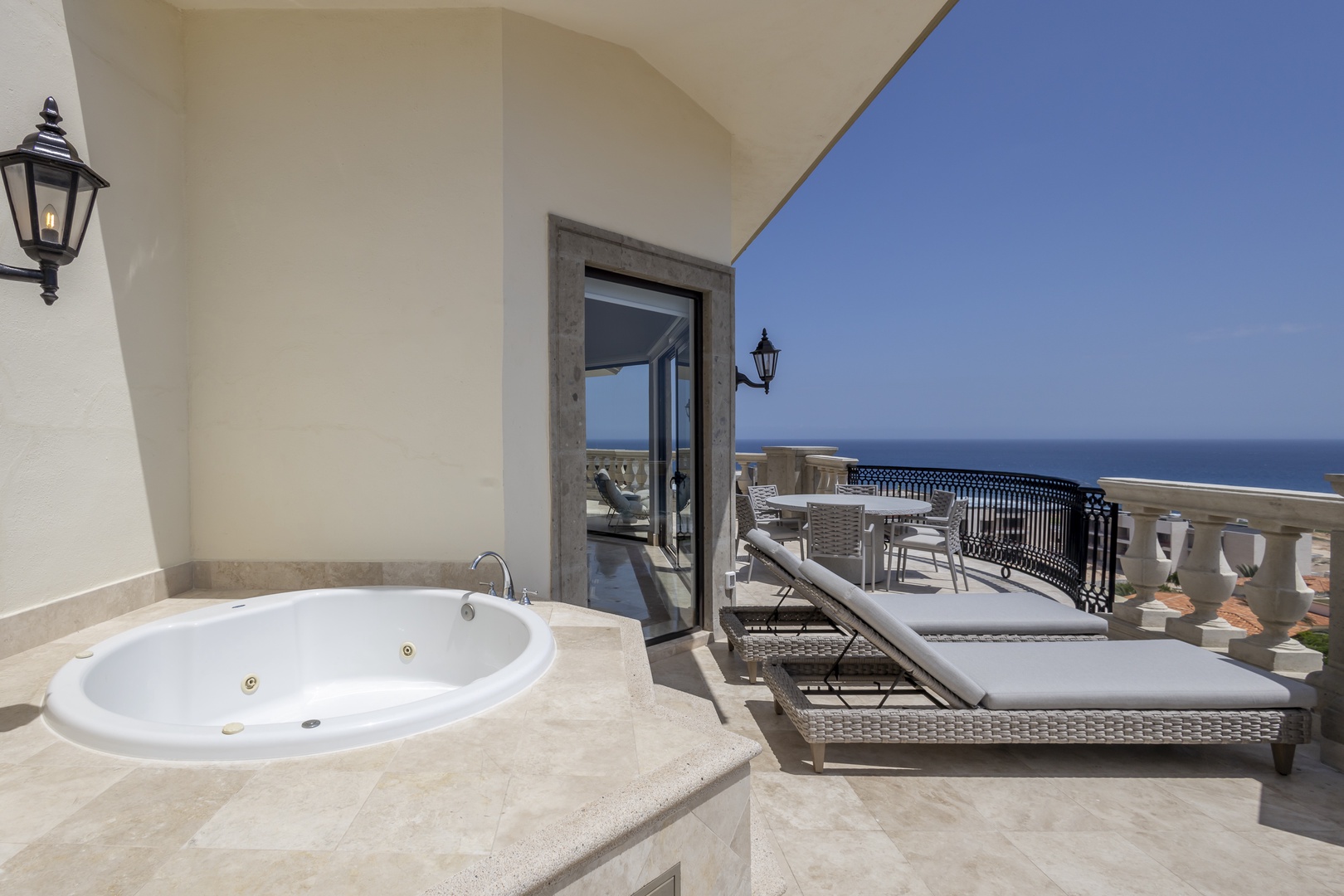 Soak away stress in your private terrace hot tub while gazing at endless ocean views, then relax on loungers under the sun—pure bliss awaits.
