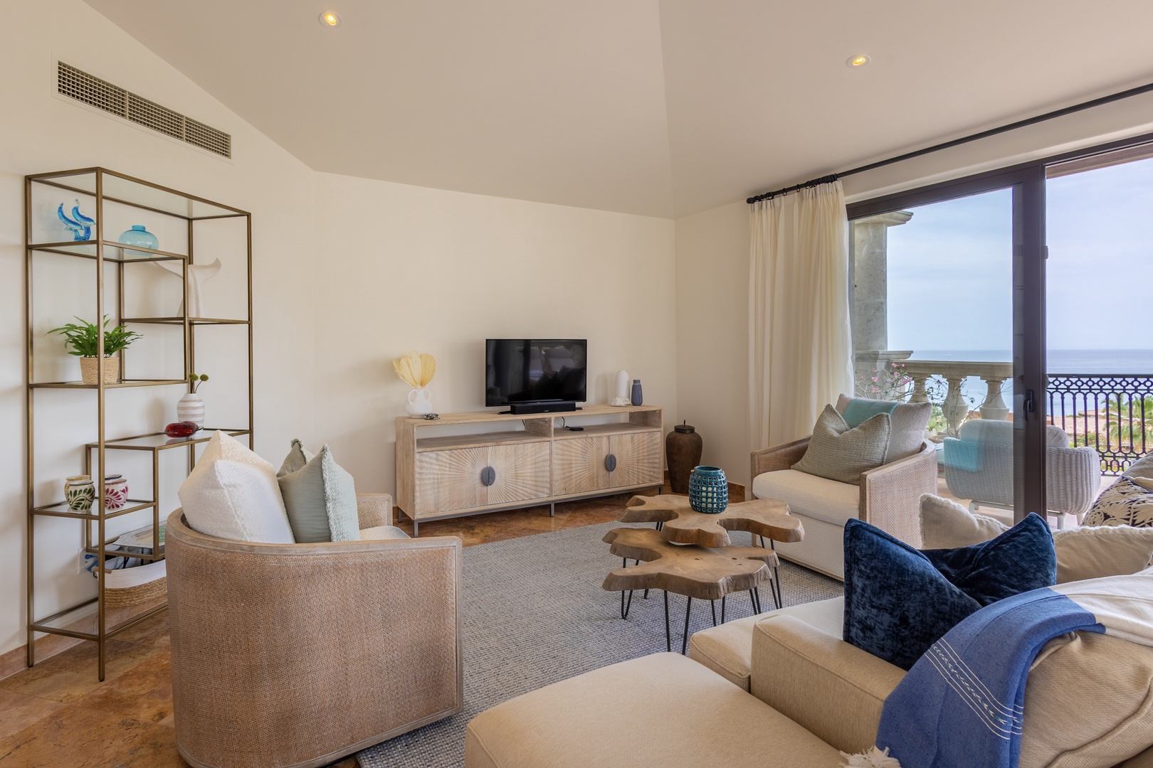 Sink into plush sofas with ocean views while enjoying modern comforts and stylish coastal décor in your serene living space.