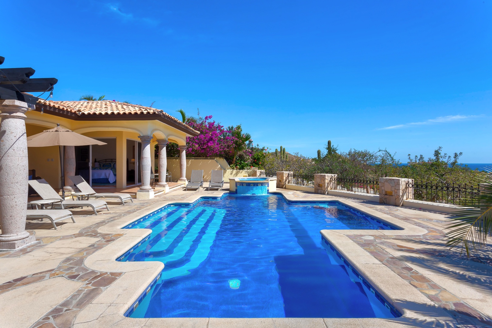 Dive into your own sparkling pool while soaking in breathtaking ocean views from this stunning villa terrace.