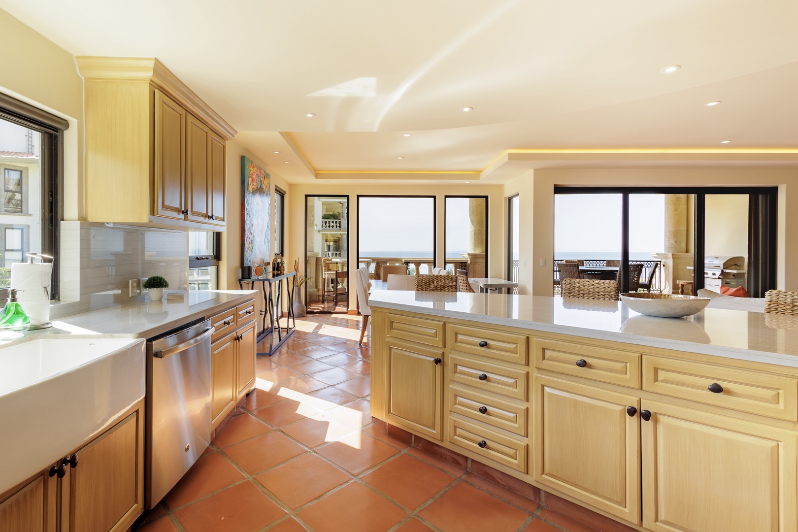 Picture yourself preparing meals in this spacious, sun-filled kitchen with sweeping ocean views and elegant cabinetry—your perfect coastal retreat awaits.