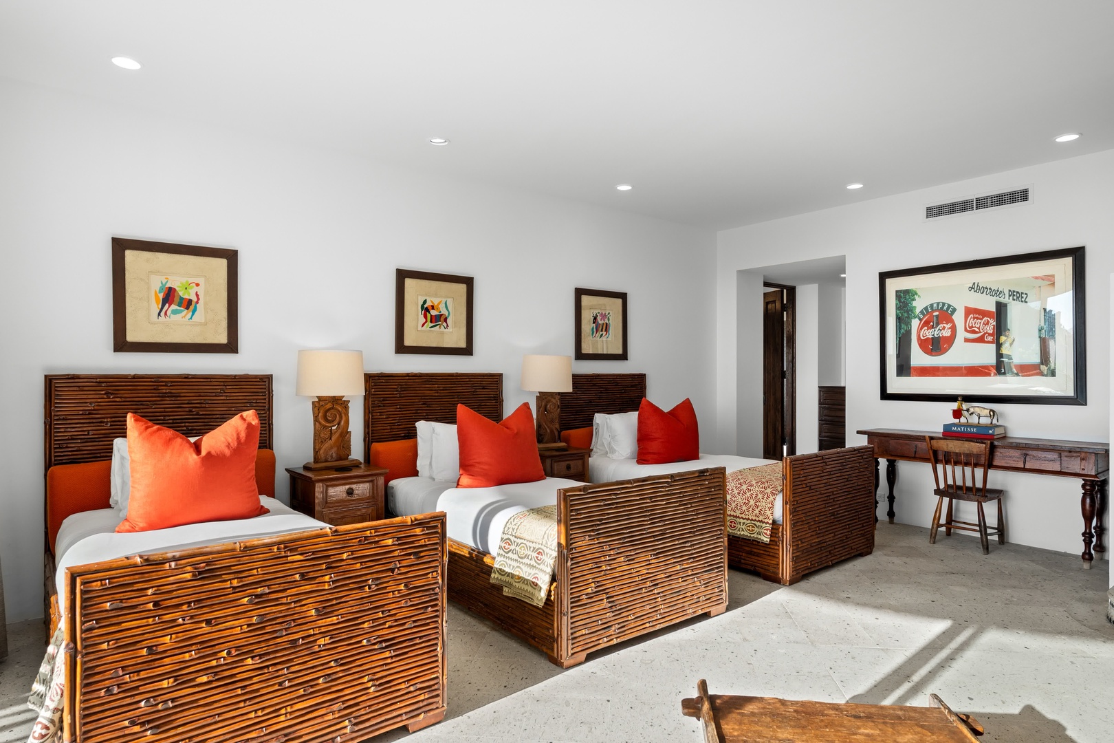 Relax in your spacious twin bedroom featuring handcrafted bamboo beds, vibrant artwork, and modern comforts with traditional Mexican charm.